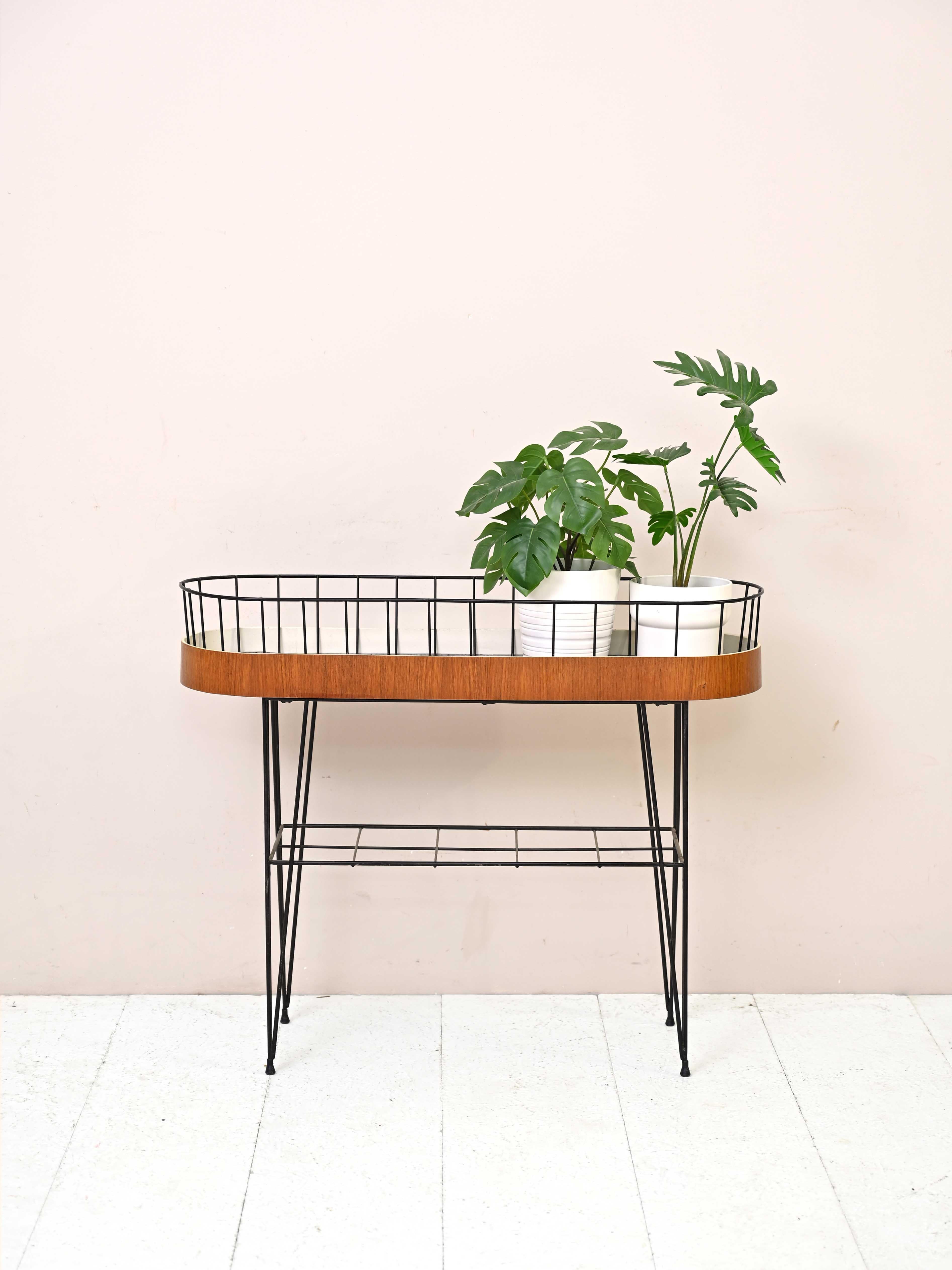 Vintage Scandinavian 1960s flower Stand.
 
Peculiar piece of furniture consisting of a metal base and curved teak wood planter border.
Ideal to keep in the house placed under the window or on the porch, it will make the environment unique and