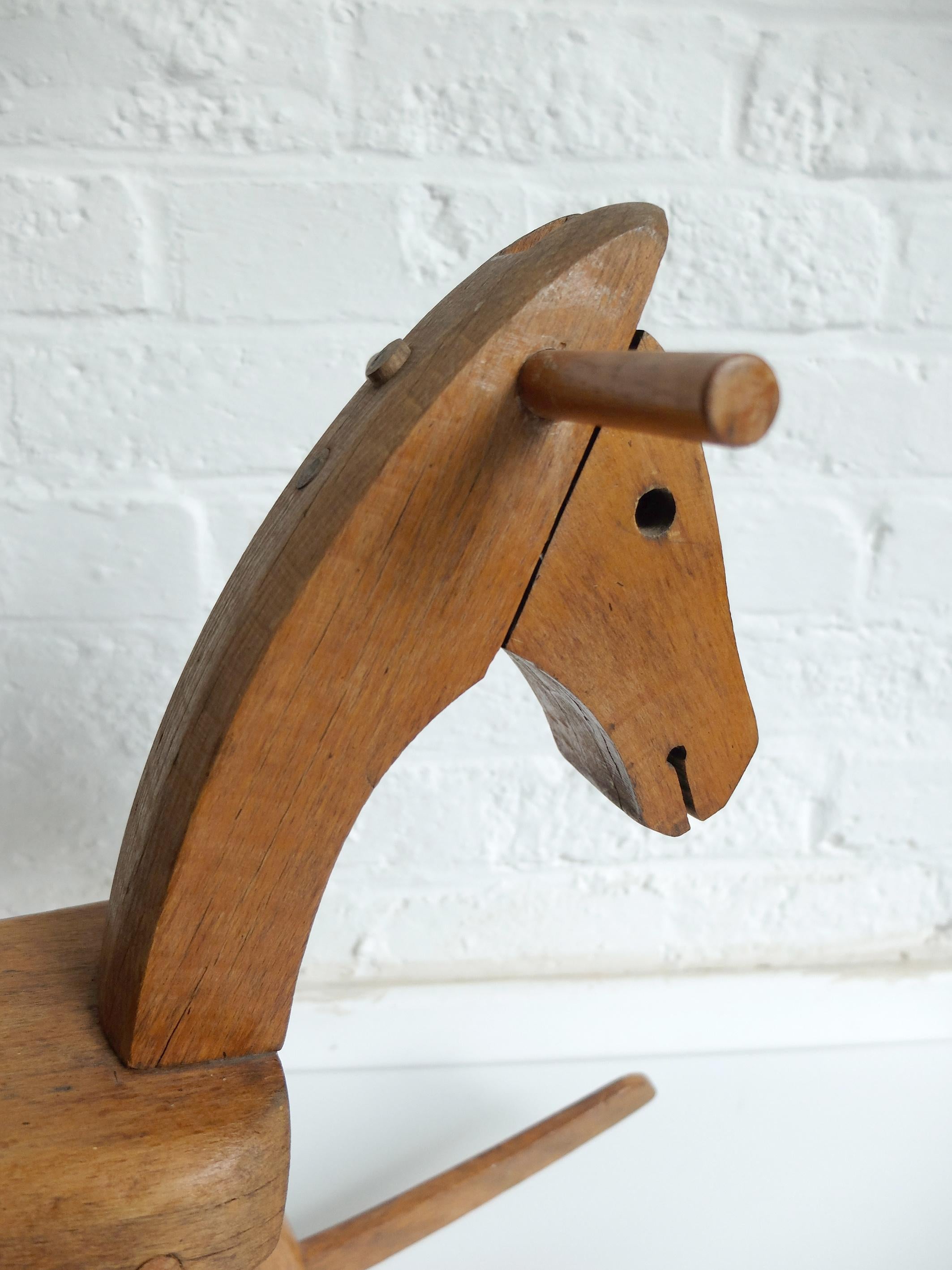 Scandinavian children's rocking horse designed by Kay Bojesen in 1936. 
The design is appealing not only to children. 

Made from massive wood beech. The lines and joinery testify of great craftsmanship. Vintage edition probably from the 1950s or