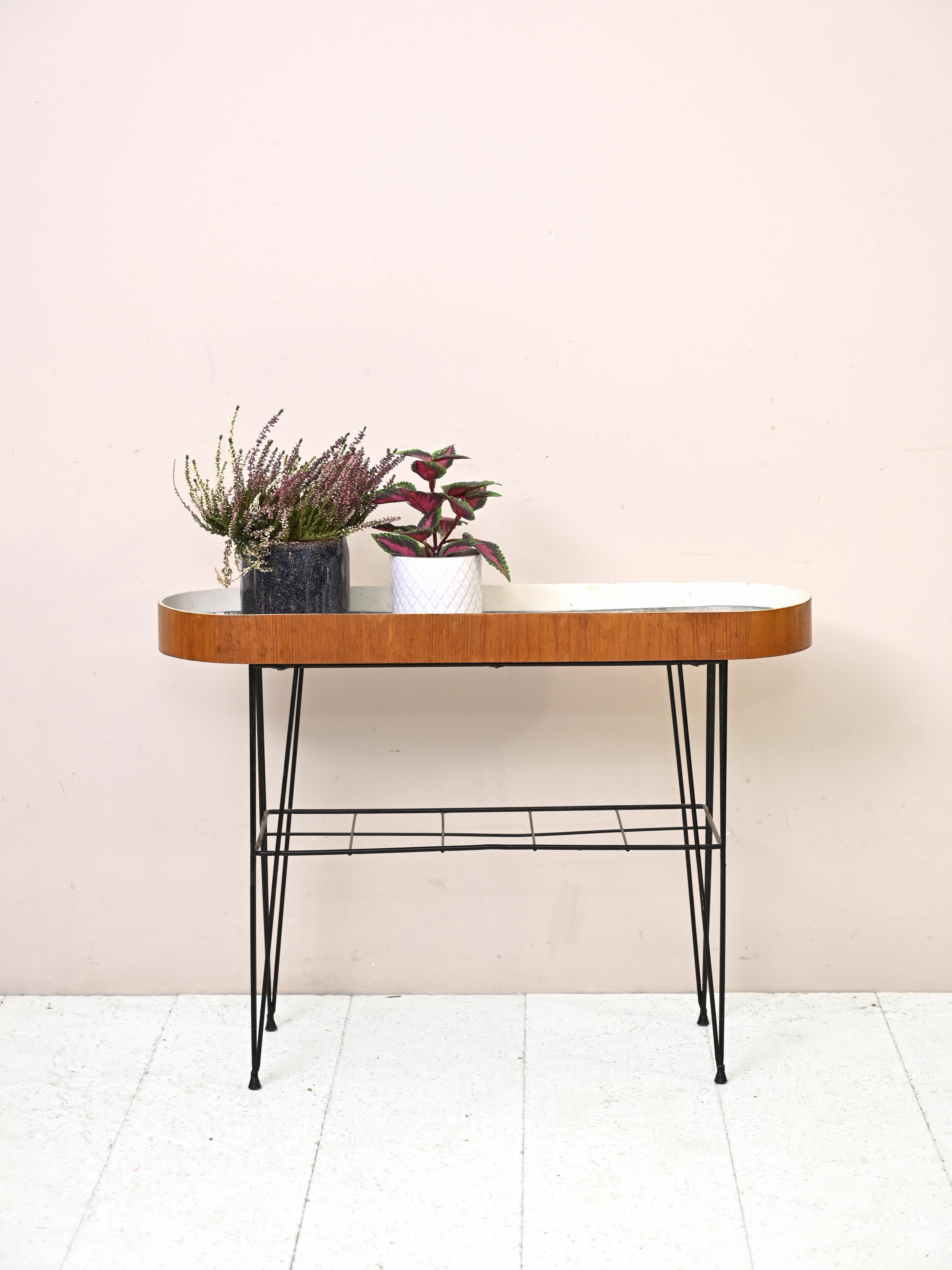 Vintage Scandinavian 1960s flower stand.
 
Peculiar piece of furniture consisting of a metal base and curved teak wood planter border.
Ideal to keep in the house placed under the window or on the porch, it will make the environment unique and