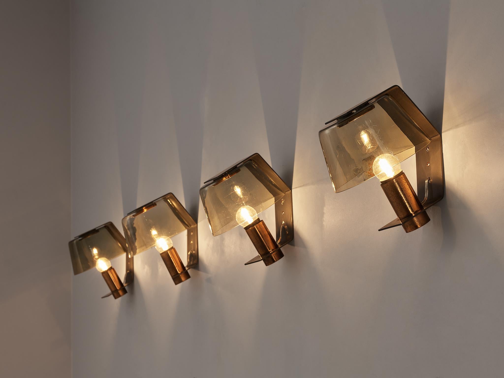 Wall lamps, metal, copper, glass, Scandinavia, 1960s

These wall lamps are designed in a special way. The designer angled the lamp that rests in a metal frame. A base in copper holds the lightbulb that is surrounded by a slightly smoked glass