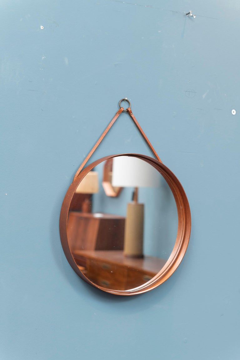 Scandinavian modern teak wall mirror by Glas Master for Markaryd, Sweden. 
Chic wall mirror made with a banded circular 13