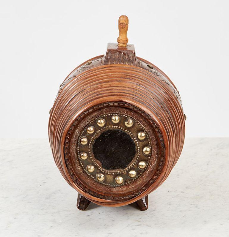 A Scandinavian spirit barrel in carved spruce with an integral stand having glass windows at each side and ends bound in willow, with chip decoration and brass studwork.  Retaining original carved stopper.  