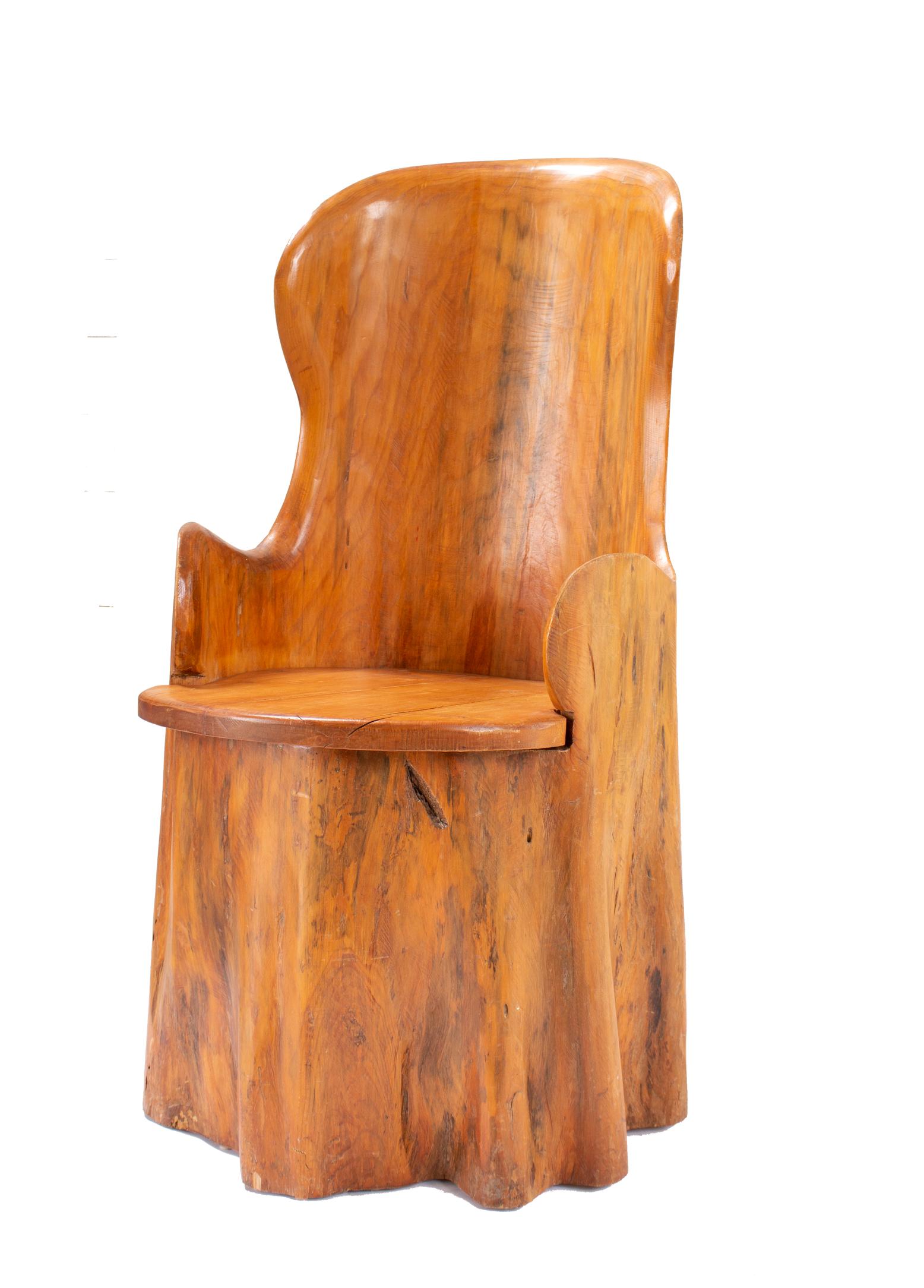 Scandinavian wooden barrel chair made in the 19th century. A circular, beautifully wooden chair with patina and soft edges hollowed out from a naturally formed tree trunk. It has an organic, natural shape almost like a draped cloth. The appearance