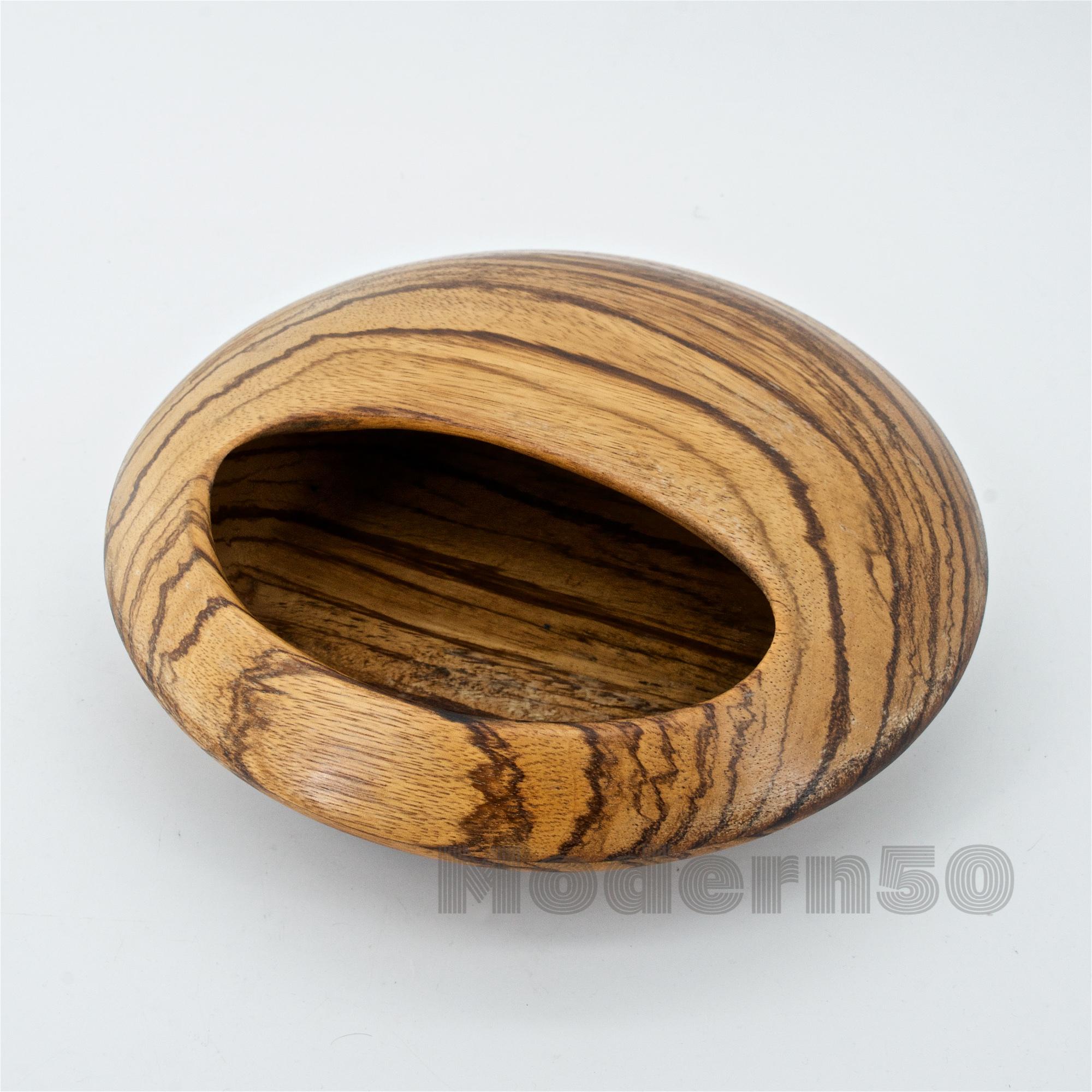 Turned shallow orb in zebra wood. Made in Sweden. Attributed to Sigvard Nilsson. Marked SOWE.