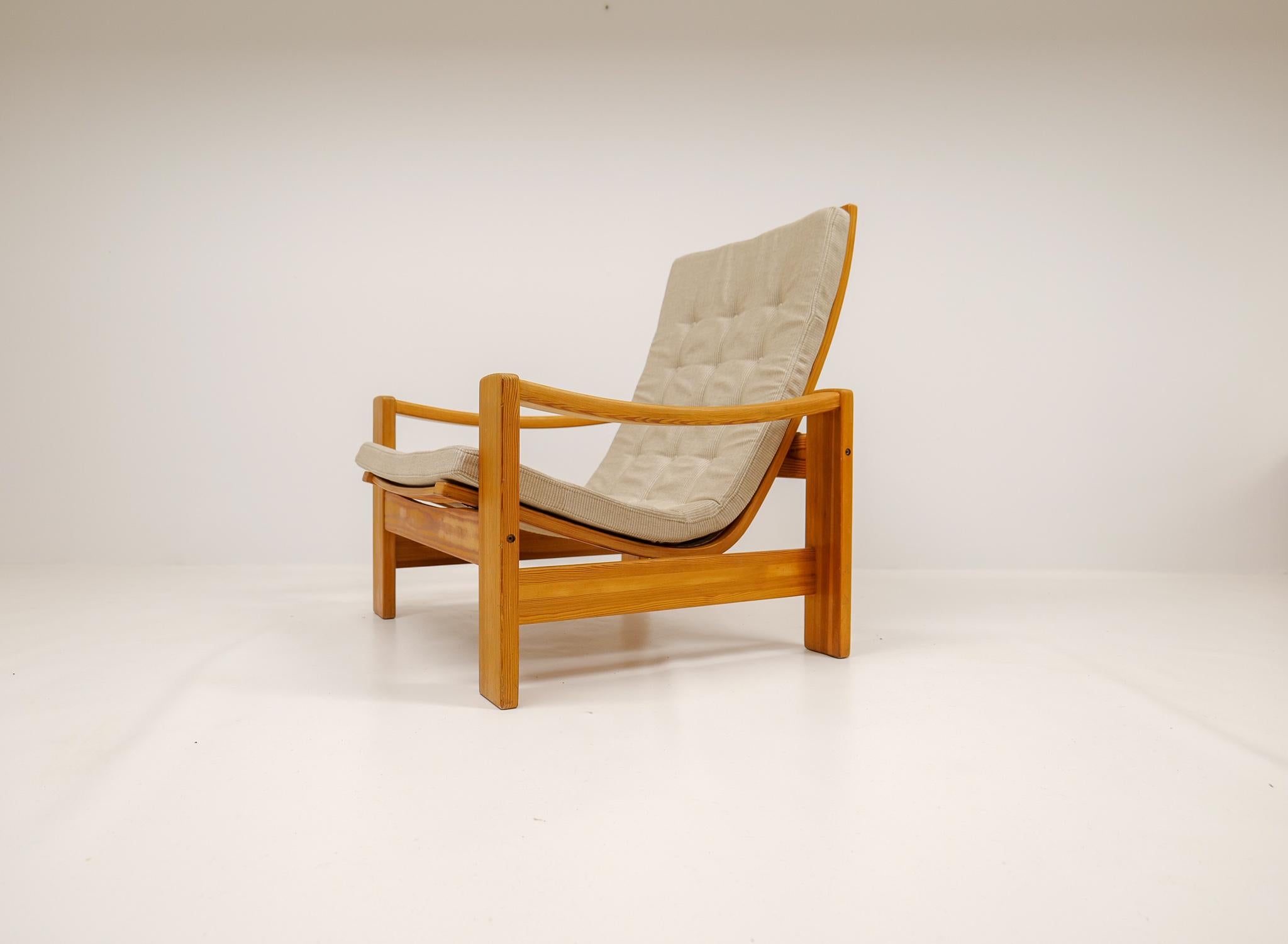 This solid pine lounge chair was designed by famous Swedish designer Yngve Ekström in 1970s and produced at Swedese. This one made in nicely rounded crafted pine with a newly reupholstered seat in fabric. 

Good vintage condition with small marks