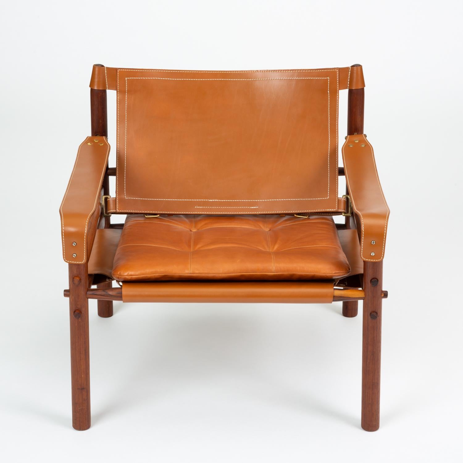 A 'Sirocco' safari chair designed by Arne Norell in 1966 and produced by Scanform in Colombia, a company licensed to manufacture the Sirocco chair for export to the US. This example features a solid rosewood frame strapped together by