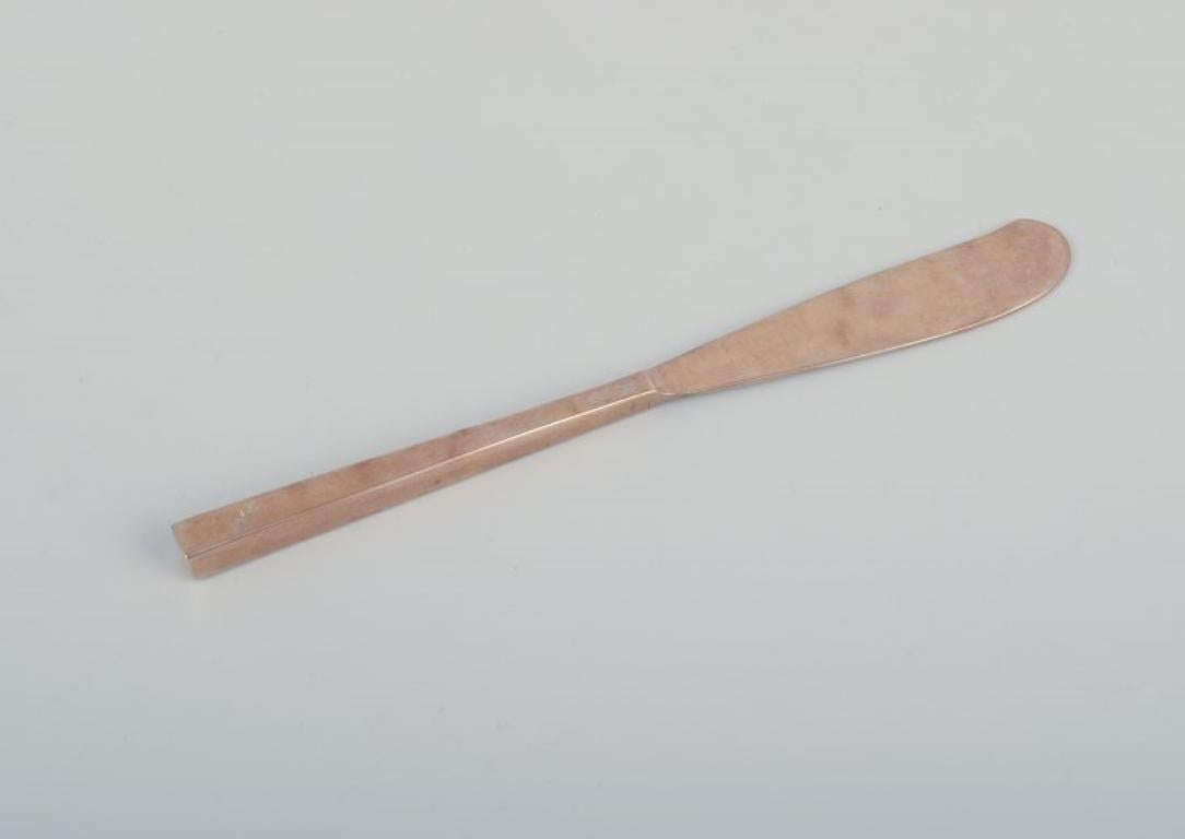 Brass 'Scanline' brass flatware by Sigvard Bernadotte. Four-person dinner set. For Sale