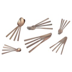 'Scanline' brass flatware by Sigvard Bernadotte. Four-person dinner set.