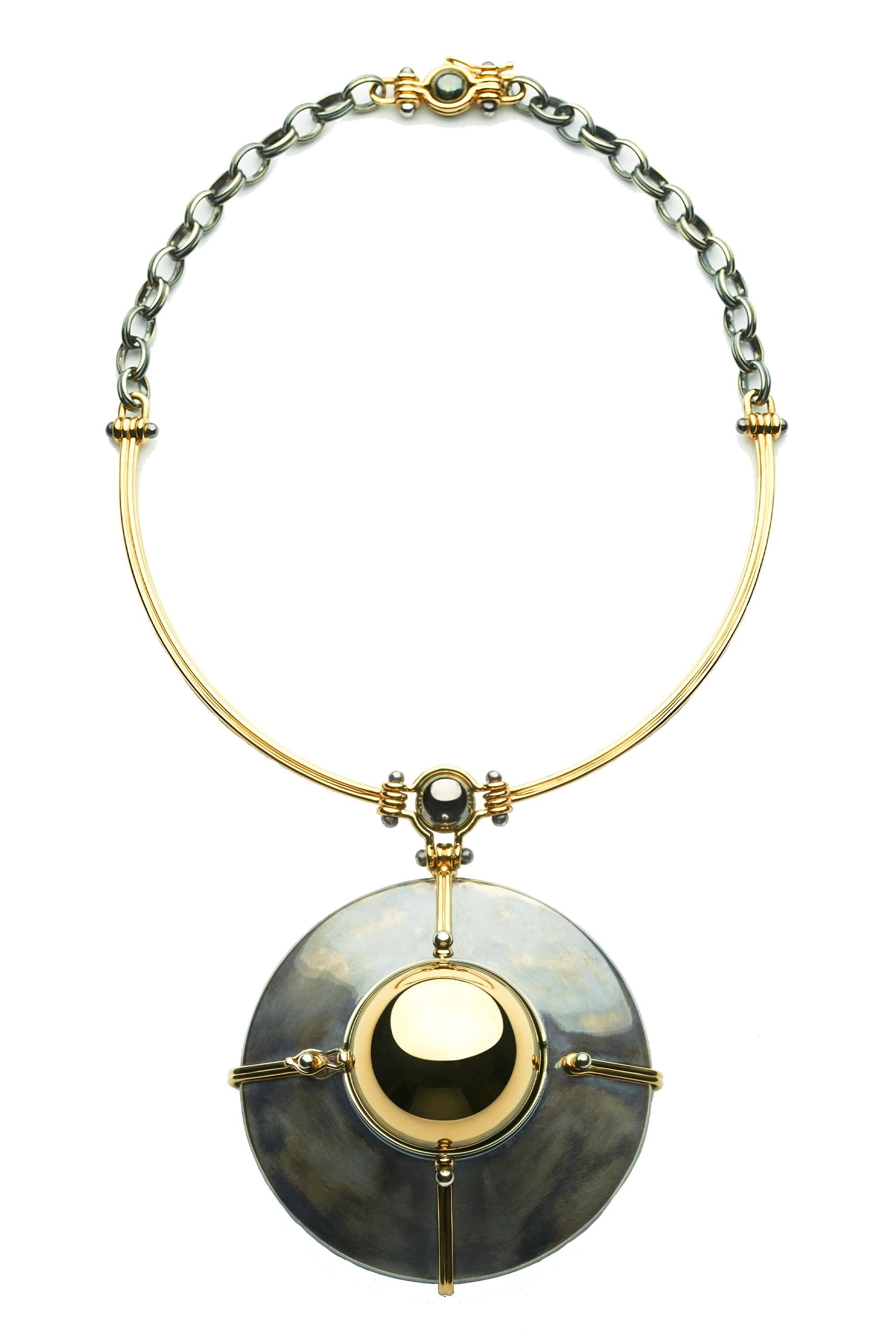 Choker pendant in yellow gold and distressed silver. A rotating sphere revealing a planet of diamonds encircled by a yellow and white gold cage, set with diamonds. 

Yellow gold wire and distressed silver chain.

Details:
190 Diamonds: 0.7 cts
18k