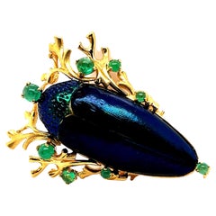Brosche mit Skarabäuskäfern und Smaragden aus 18 Karat Gelbgold von Gilbert Albert