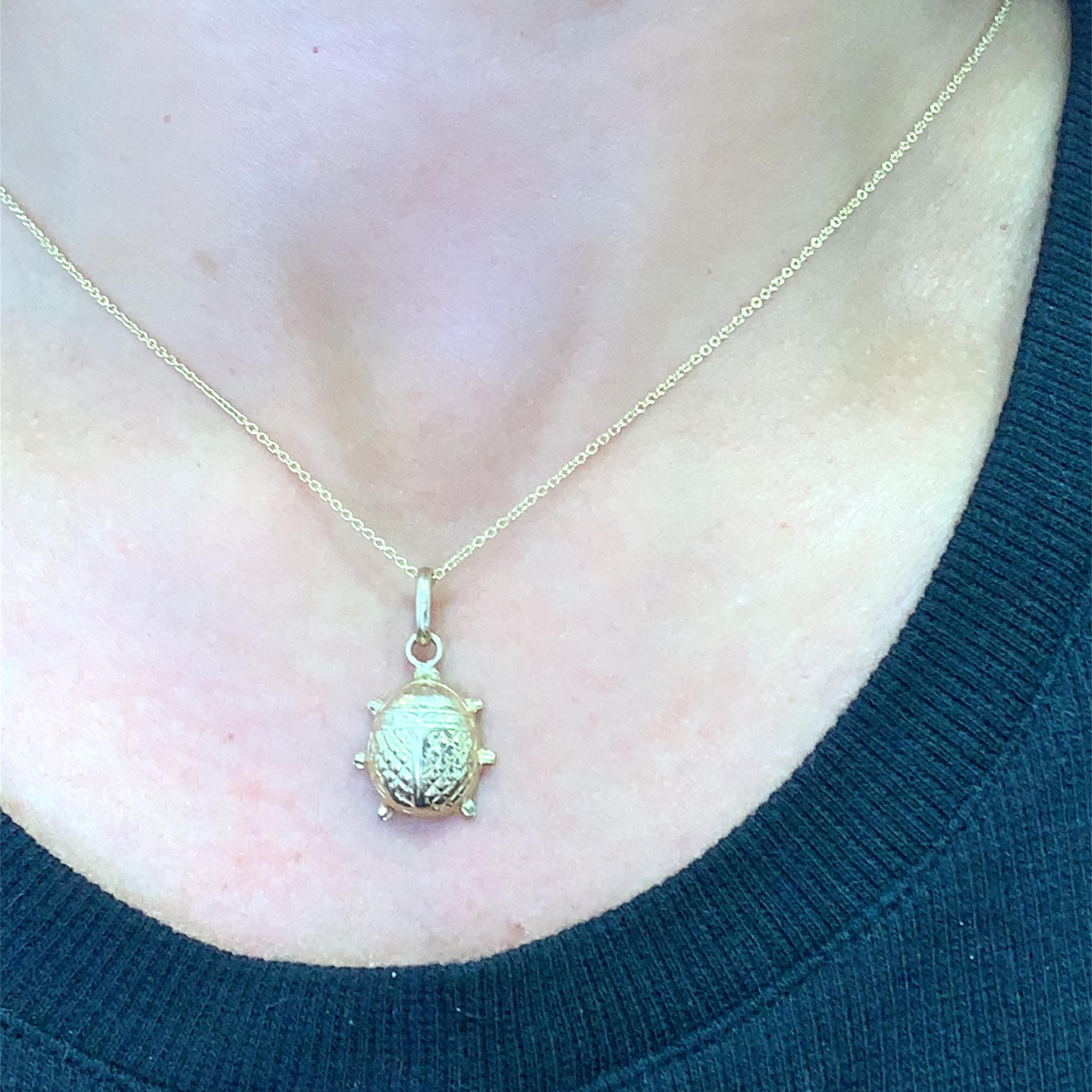 Embrace ancient symbolism with this charming yellow gold ladybug pendant. Designed in a scarab beetle form, revered across cultures for its protective and luck-bringing qualities, this pendant presents an elegant way to carry an emblem of positivity