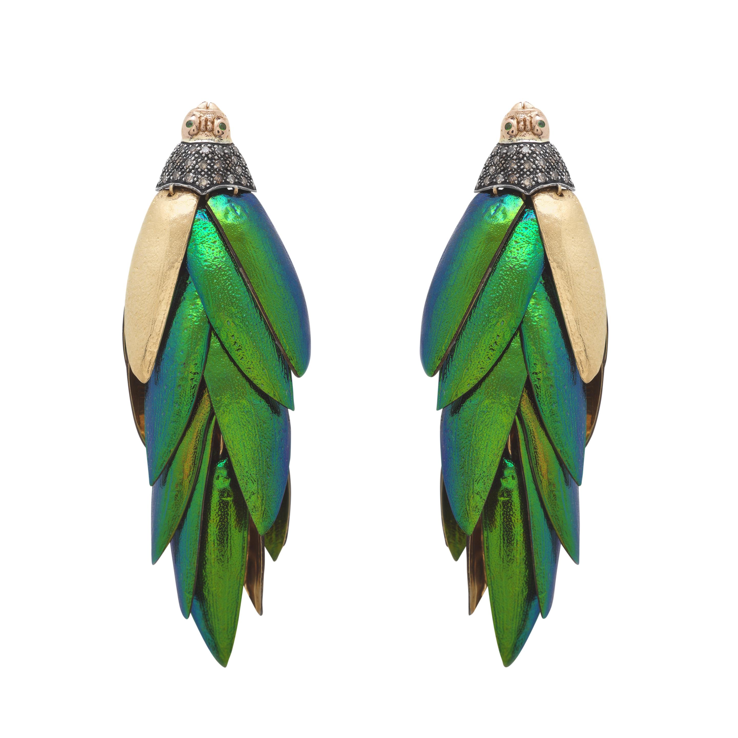 The shimmering iridescence of real scarab wings complements the luminosity of 18k recycled yellow and rose gold in these Scarab Bunch Earrings. Fashioned from over 40 real scarab wings, the gold wings contrast with the beetles’ wings’ appealing,