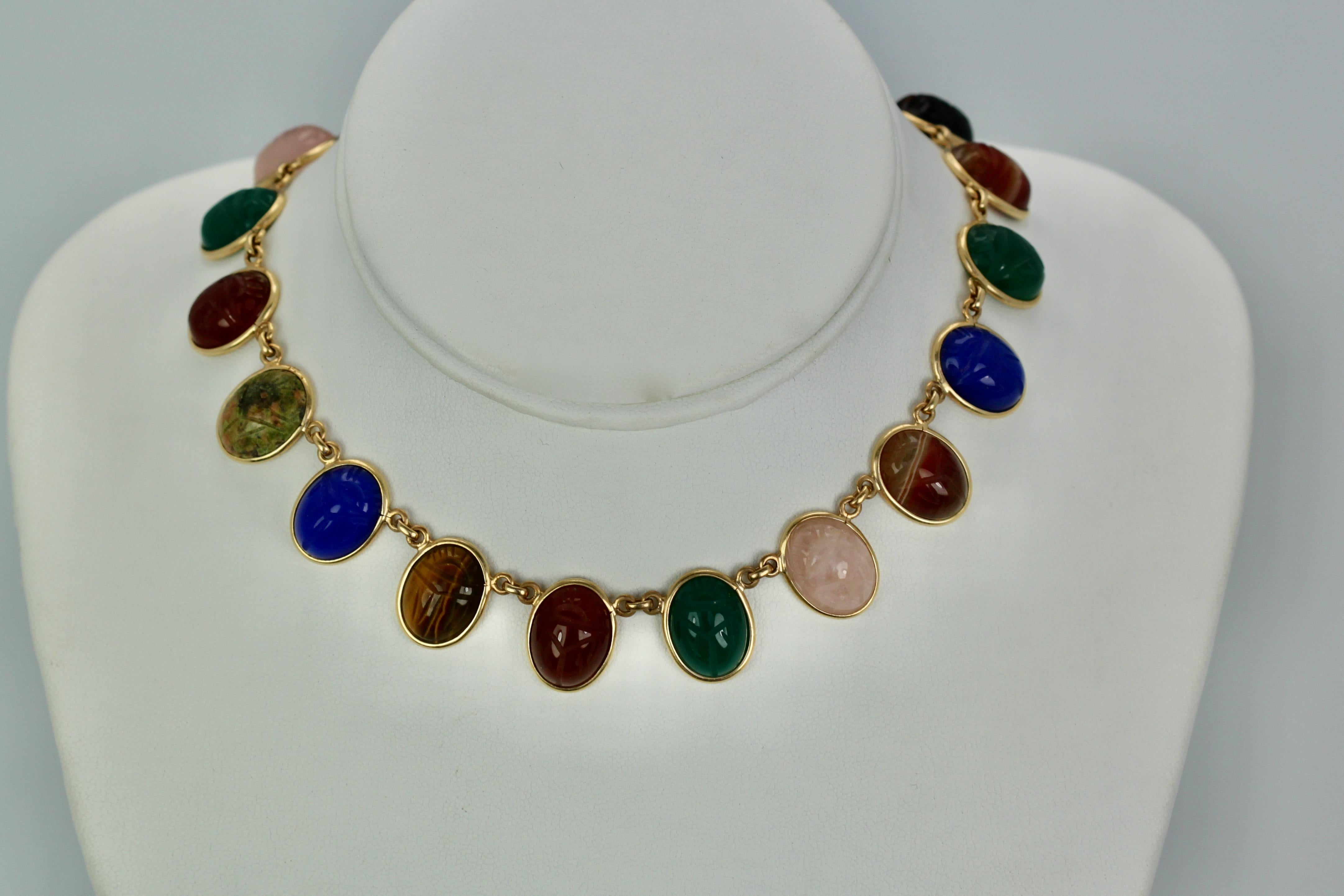 This multi stone scarab necklace is 13.5 inches long and comes with matching 2 scarab bracelets.  When both bracelets are added to this necklace it is 27.75 inches long.  The bracelets measure 7.25 inches if you added one bracelet to the necklace