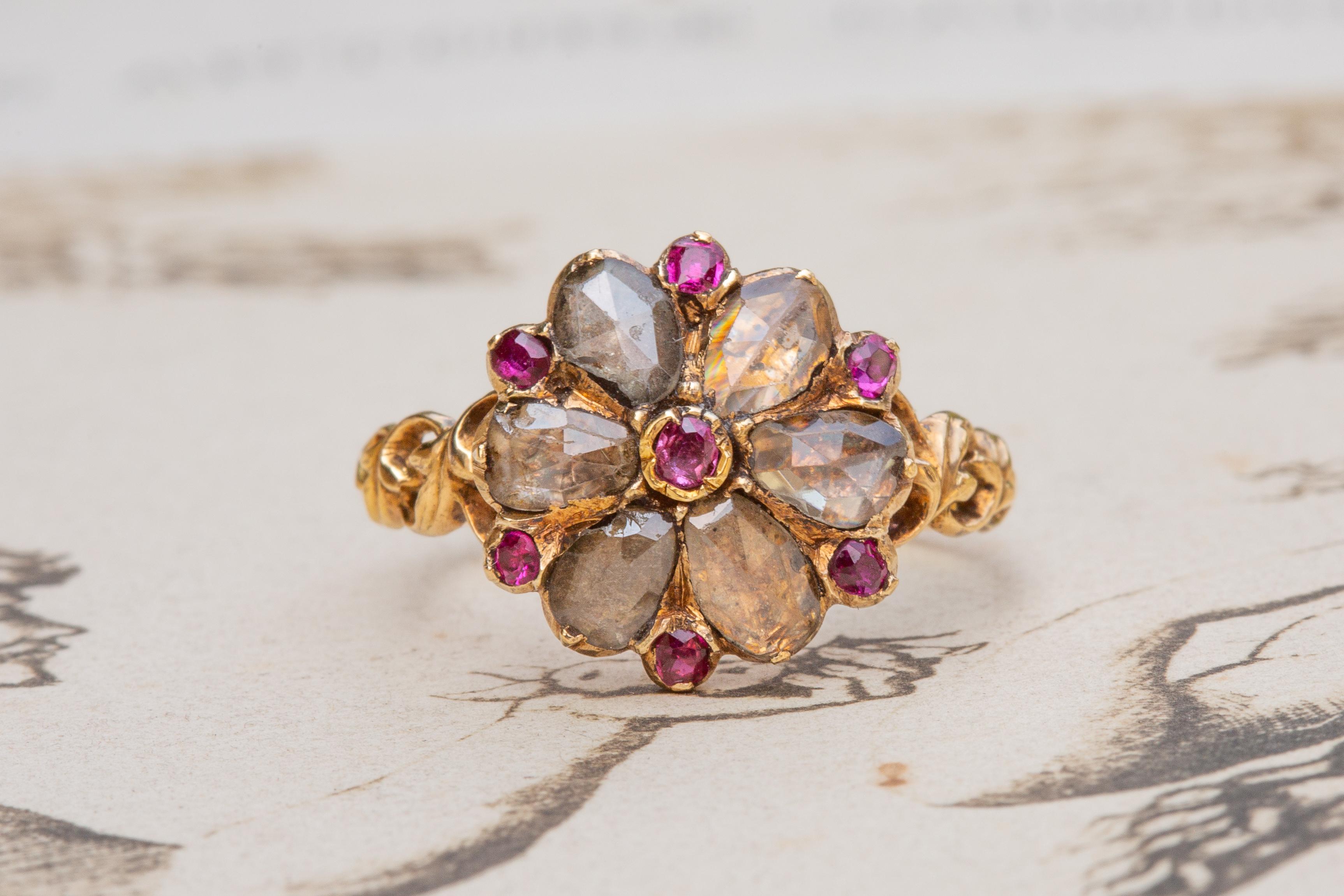 A sublime hard-to-find antique French flower cluster ring dating to the very early 19th century, circa 1800-1820. A superb example of fine Georgian period jewellery, this ring was crafted in 18K gold and displays exceptional craftsmanship. The
