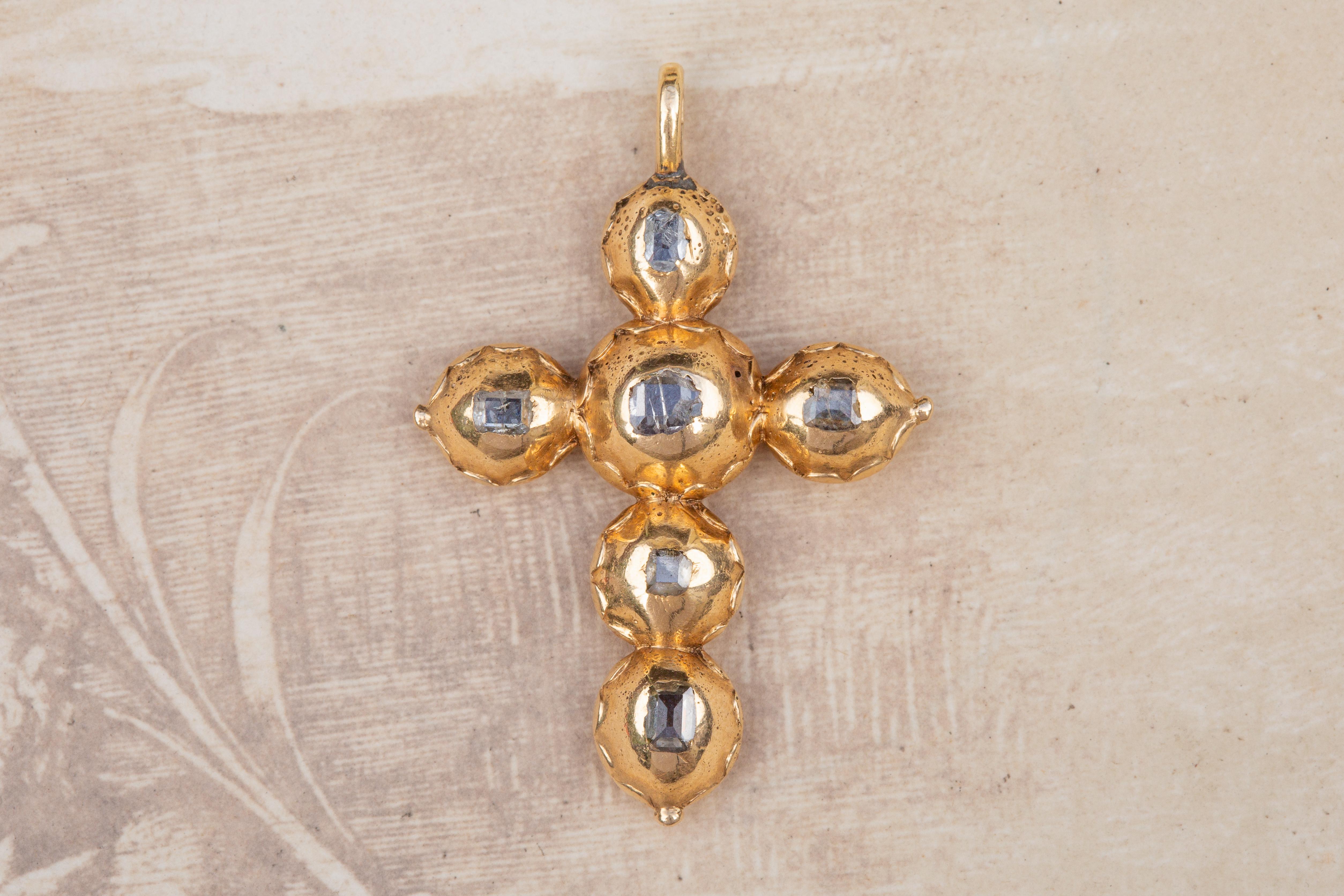 A scarce early 18th century Baroque table cut diamond cross pendant, circa 1700-1720 and probably Western Europe (Netherlands or Flanders). 

The cross is crafted in 14K yellow gold, and set with six table cut diamonds. Each of the diamonds are