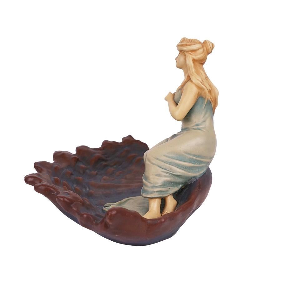 Offering this scarce, signed Bernard Bloch (Bohemia) faience vide-poche or figural tray featuring a full-bodied maiden figure atop a shell design. Tray is hand painted and signed on the underside 