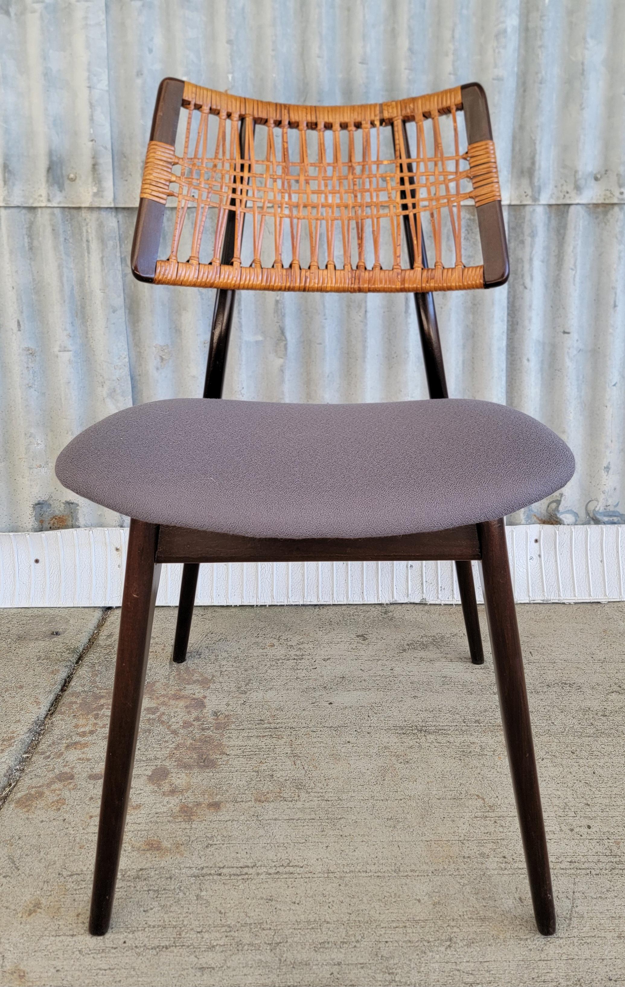 A Heywood Wakefield single dining chair with cane back. Re-upholstered and refinished. Would work well as a desk or side chair. Cane to back seat rest has loss.