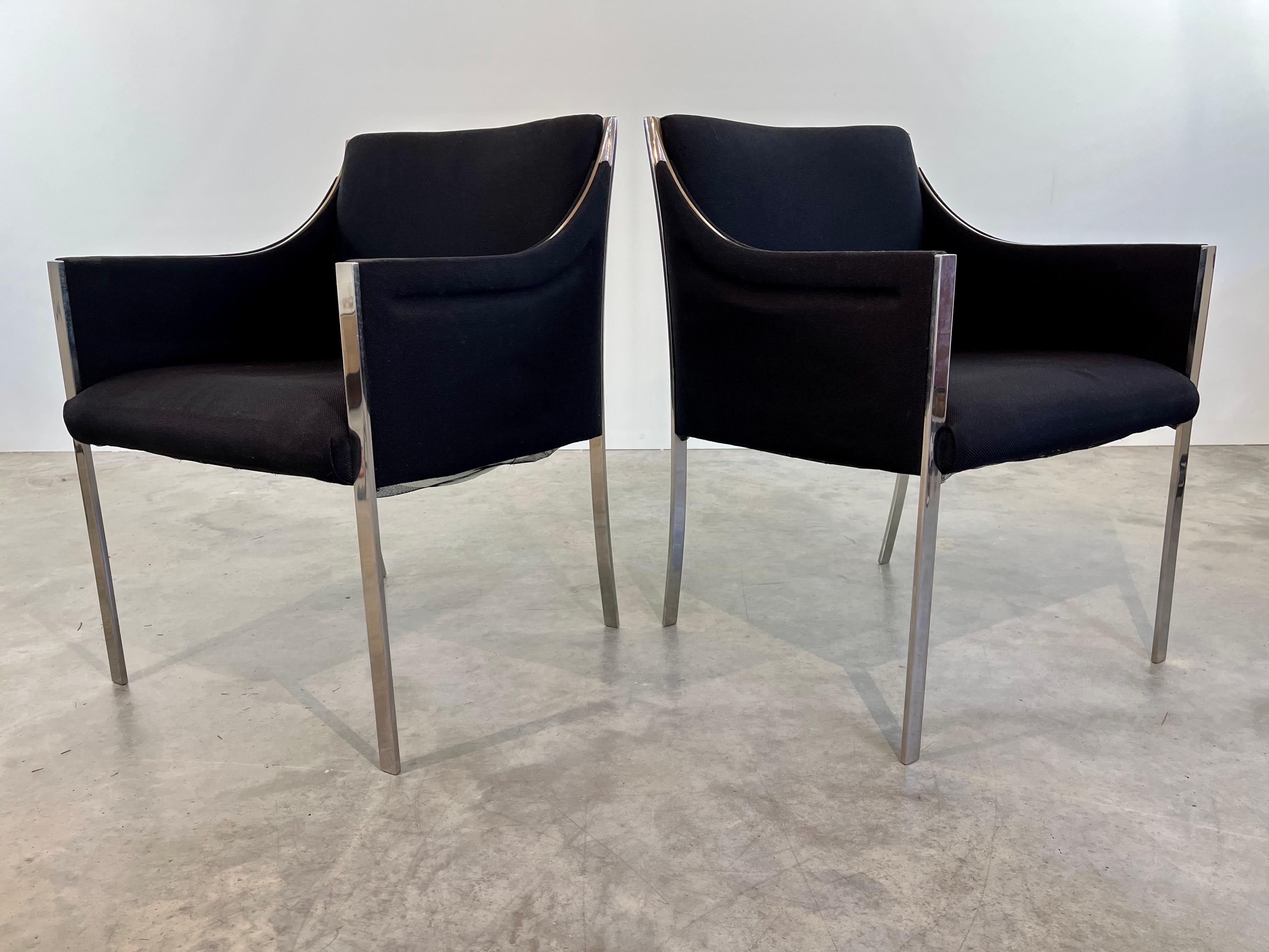 Pair of rare early easy chairs designed by Jens Risom having solid chrome steel frames with Knoll wool fabric in black. Elegant lines and a design that stands out. 
Beautiful solid condition with tag present underneath of one chair. 
Measures:
