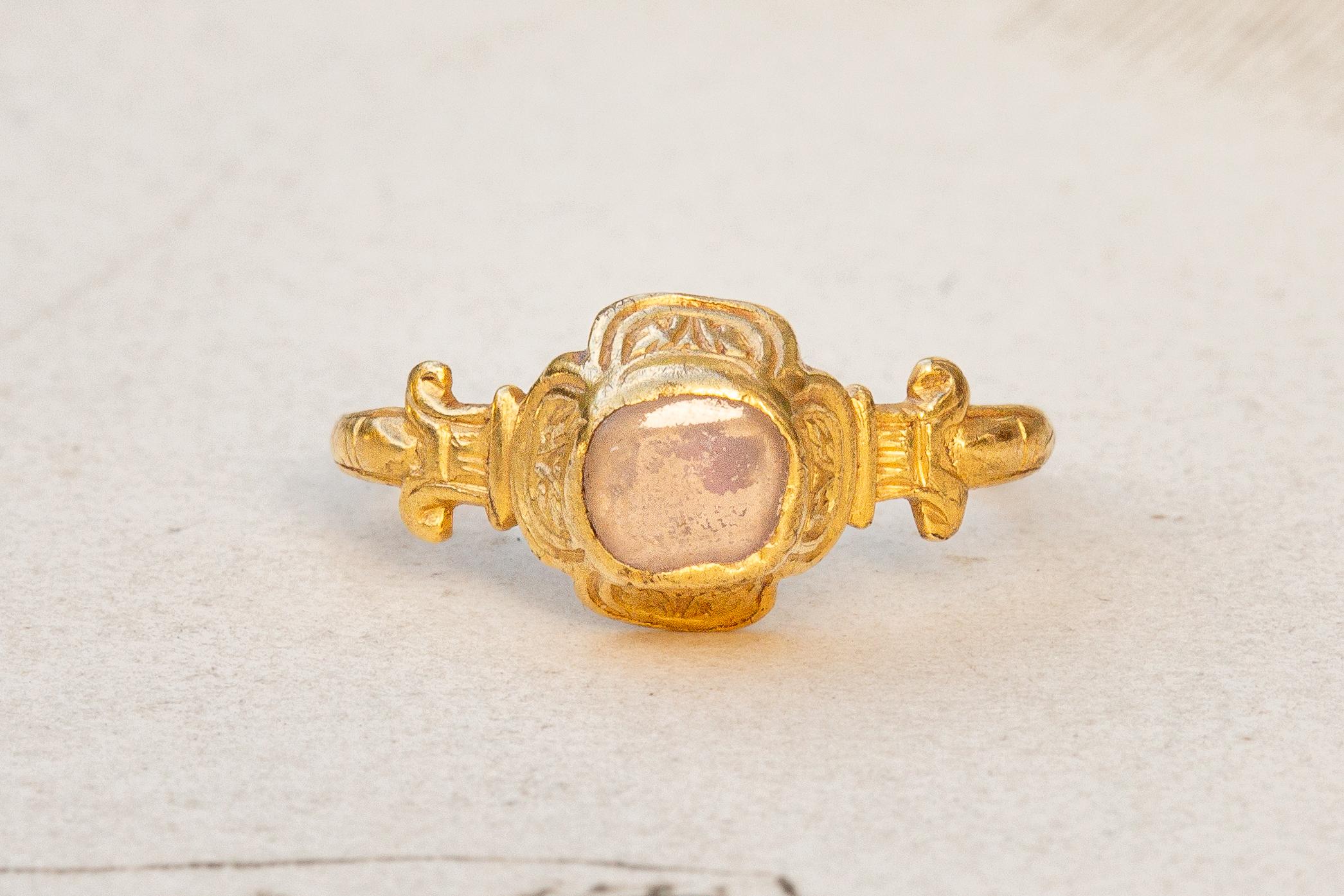 A scarce late Renaissance gold ring, made in Western Europe, circa 1580-1620! 

The quatrefoil bezel takes the form of a flower petals and contains a shallow table-cut rock crystal. The boxed bezel is cuffed on each side and intricately chased with