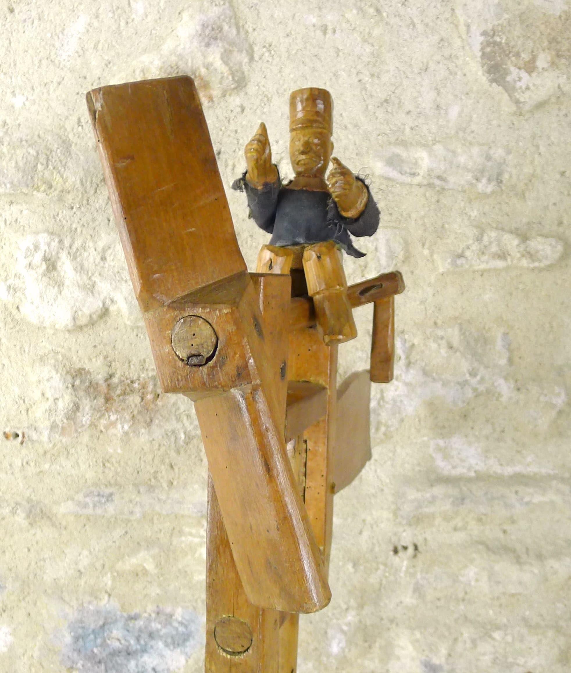 In shape of French policeman
Screw is spinning because of the wind and make a wooden noise.
Used to scare animals.

Rare, from France.