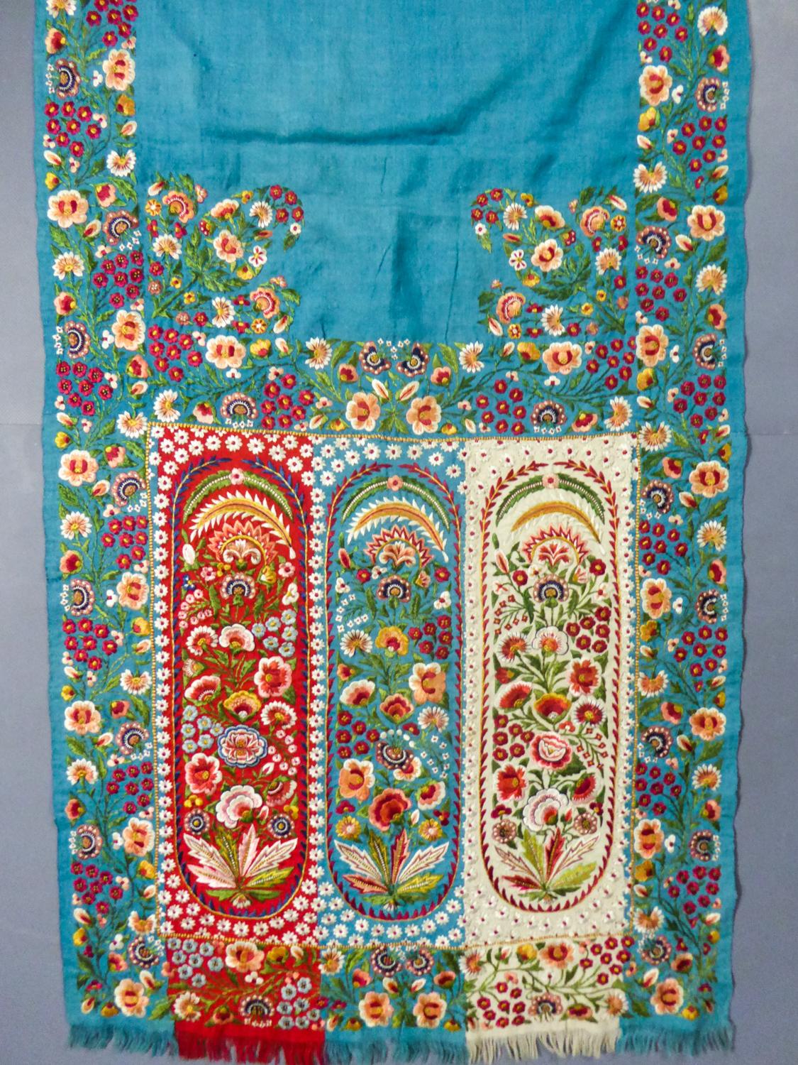 Circa 1830/1860
British India Company

Rich turquoise pashmina scarf densely embroidered with harlequin palms, Indian production from Delhi in the 19th century for fashion in England and Europe. Turquoise pashmina twill background with polychrome