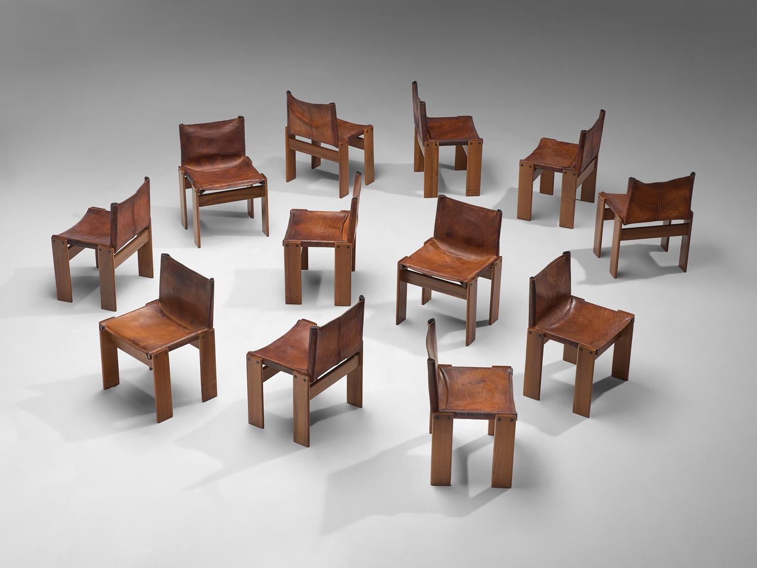Arfa & Tobia Scarpa, Set of 12 'Monk' dining chairs, oak and cognac leather, Italy, 1974.

This original set of twelve chairs is strong and sturdy in their design. Finding this amount of chairs as an original set with this patinated condition is