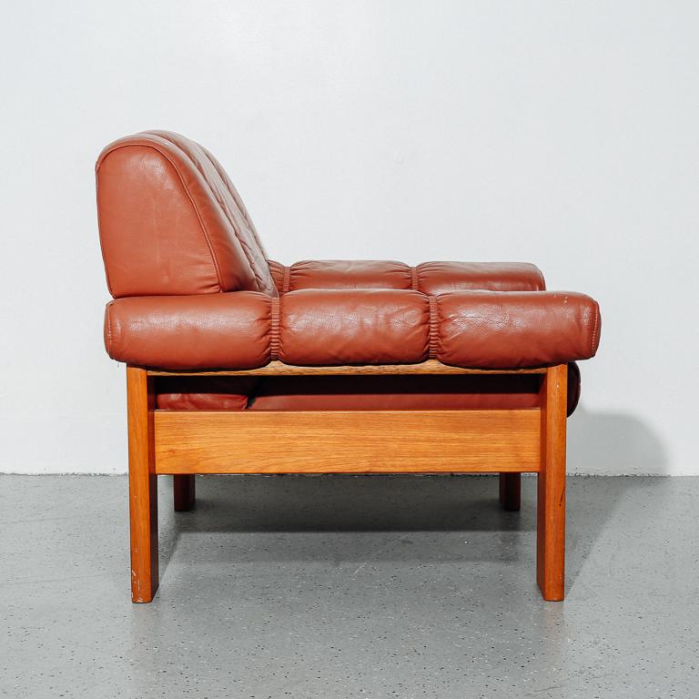 Lounge chair with brown leather upholstery and chunky oak frame. Manufactured by Ekornes.
