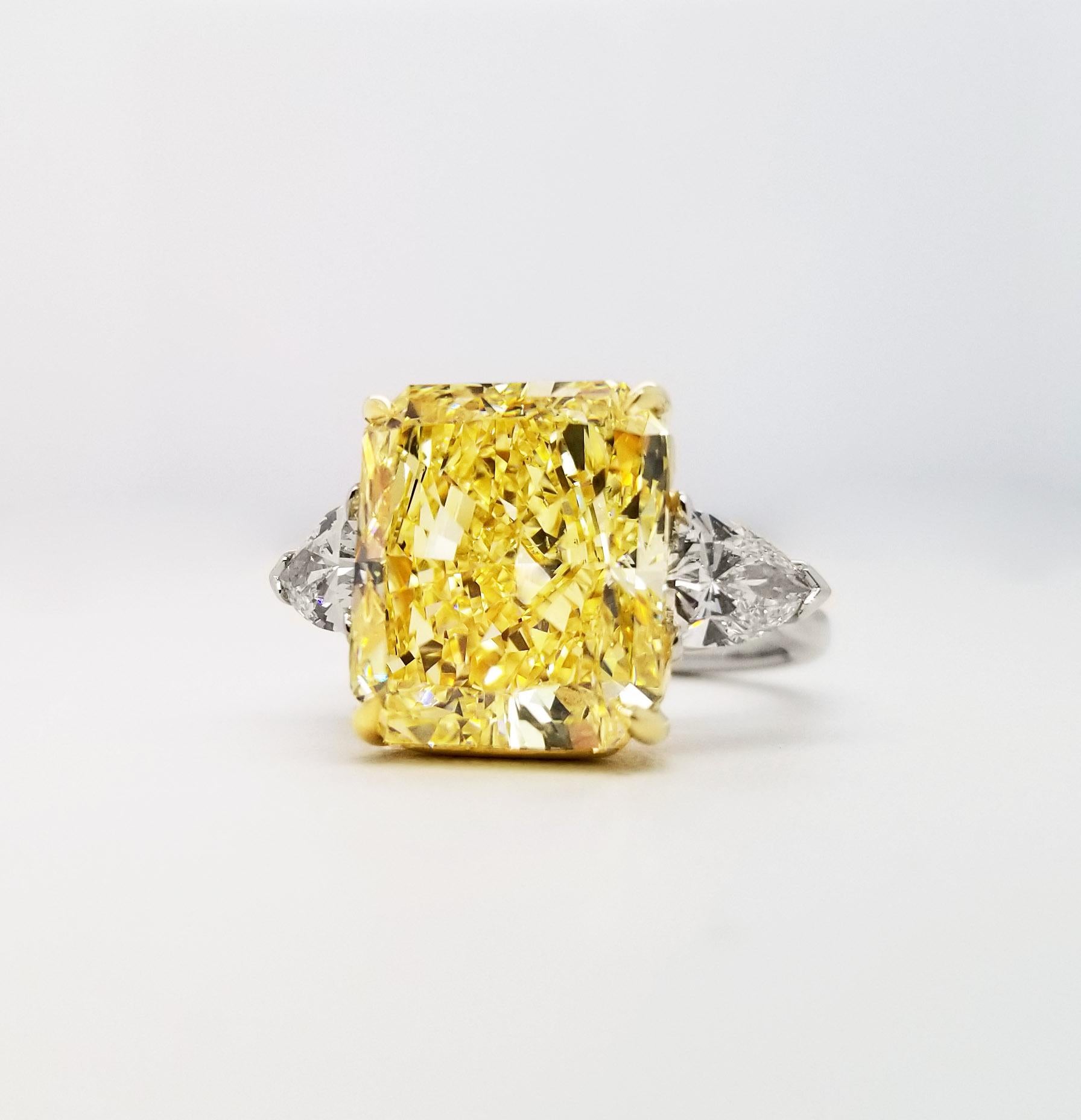 A Classic SCARSELLI  Engagement Ring with an astonishing 10-carat Fancy Intense Yellow Radiant Cut Diamond set in a handmade ring 18k gold seat finished in platinum (See certificate picture for detailed stone's information). The center diamond is