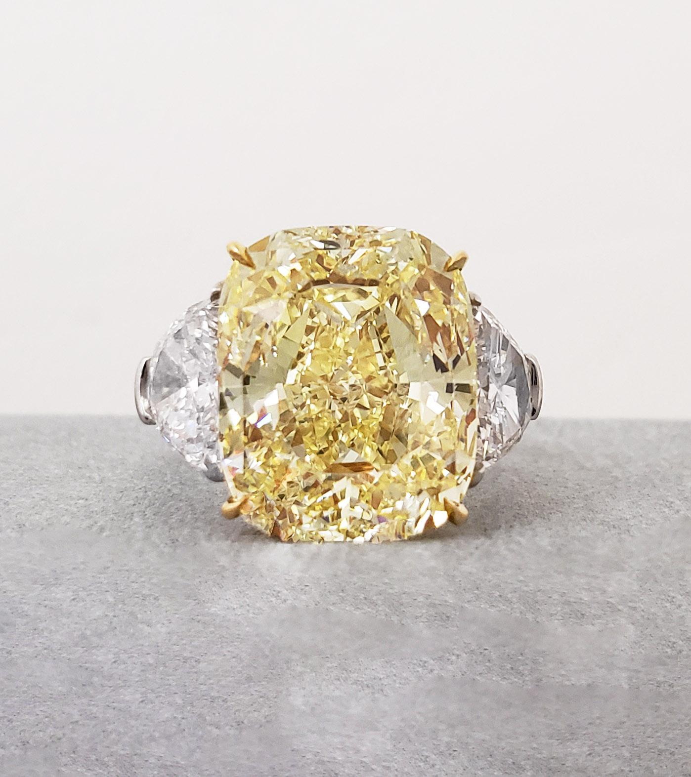 From SCARSELLI the world-renowned Natural Fancy Color diamonds, this 11-carat Fancy Yellow cushion cut diamond set in an 18k yellow gold and platinum ring flanked by half-moons E VS1 diamonds totaling 1.46ct Wonderfully tailored, this ring