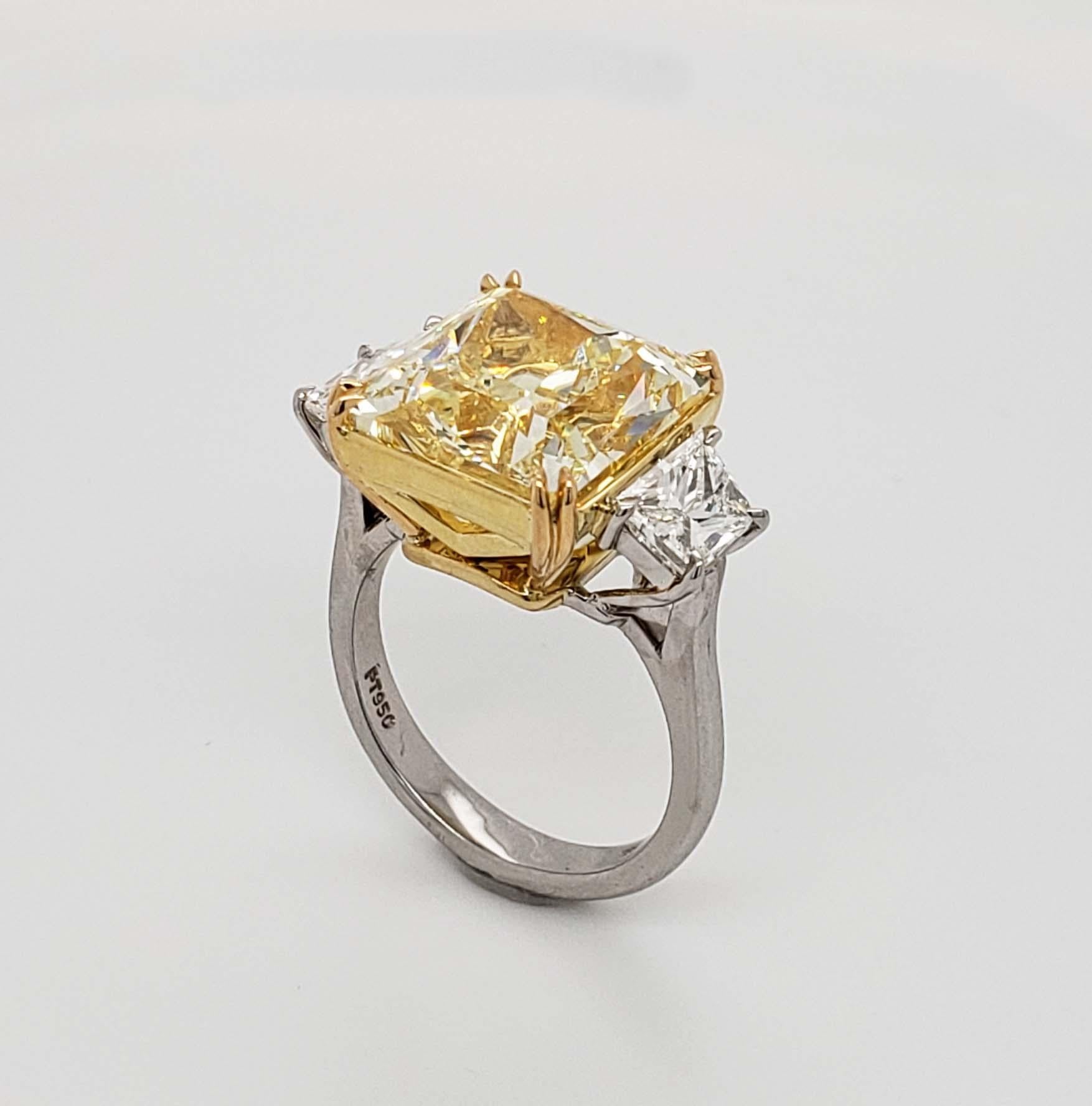 From SCARSELLI this 11.21 carat Fancy Yellow Radiant Cut Diamond is VS1 clarity and flanked by white brilliant cut tapered diamonds (2=1.02 carat) in a handmade platinum ring.  Wonderfully tailored, this ring transitions from day to evening