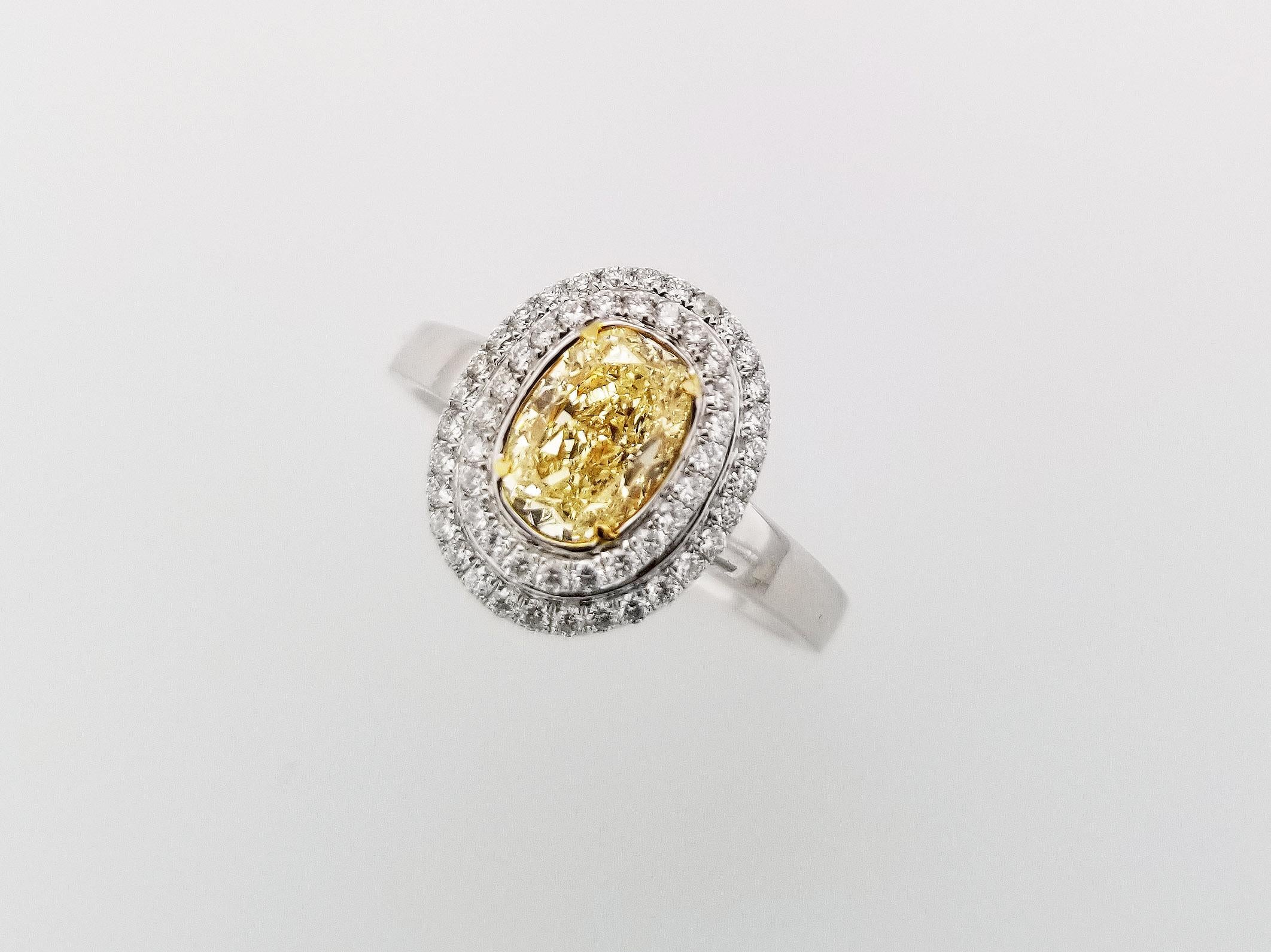 Mother's Day Gift Guide!

Halo Ring with 1.20 Carat Fancy Light Yellow Diamond center stone, surrounded by two rows of round white diamonds, TCW 0.29. The center stone has a clarity of SI1 and the 18k white gold band can be resized upon request. All