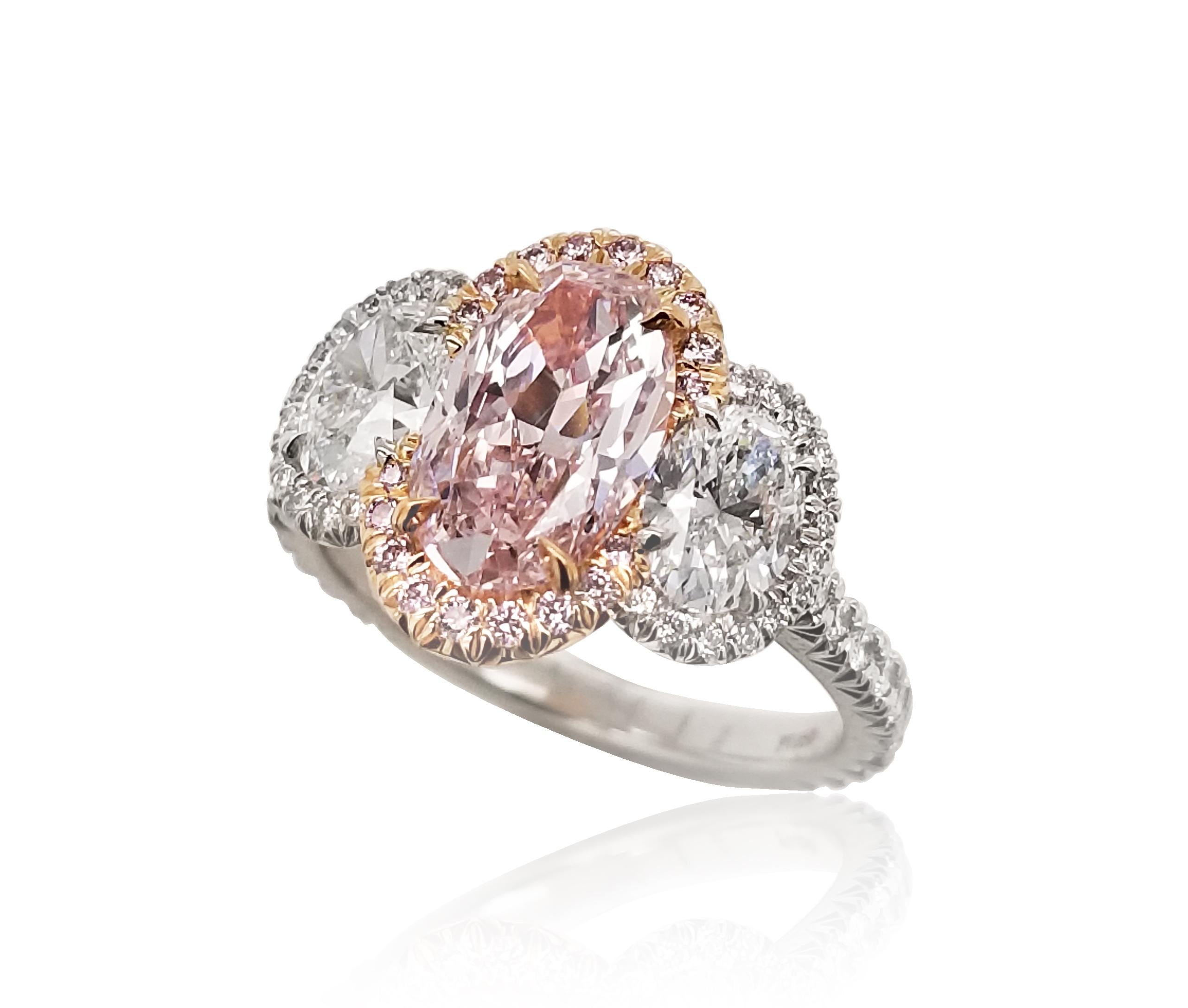 SCARSELLI is featuring a natural fancy pink oval cut diamond of 1.54 carat, VVS2 clarity set in an 18k yellow gold head and, platinum band ring. This exceptional center stone is flanked by a couple of white diamonds 0.50 carat each VS1 Clarity and