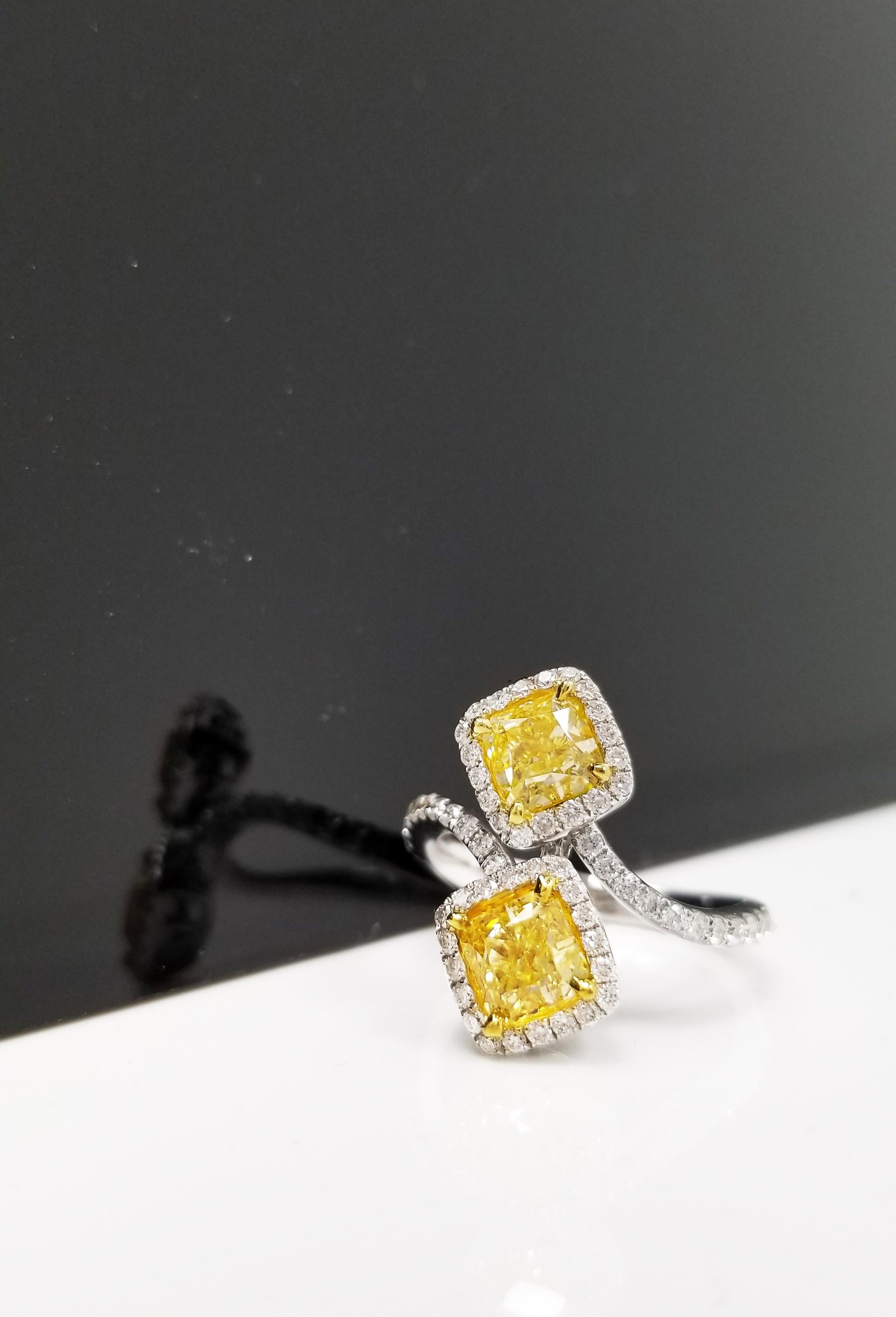 From SCARSELLI, spectacularly designed ring in 18k white gold featuring 1.00 & 1.03 carat Fancy Yellow Radiant Cut Diamonds GIA certified (see certificate pictures for detailed stones' information) set with round brilliant diamonds totaling 0.55