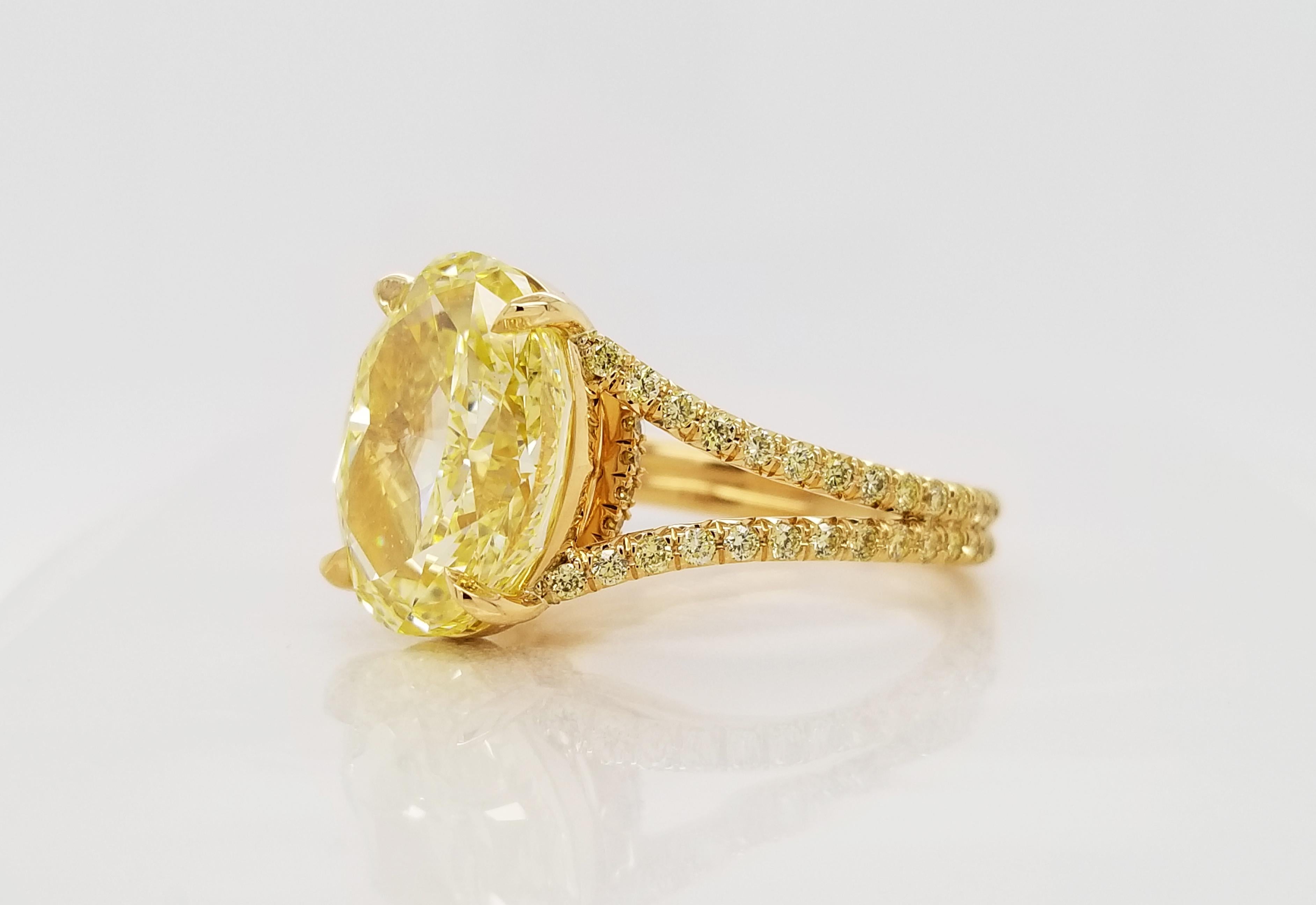 From SCARSELLI, a simply important ring featuring a 6.00 carats Fancy Intense Yellow Oval cut diamond (GIA VS2 Clarity Certificate 5202490787) surrounded by 0.48 carats of Fancy Intense Yellow Round brilliant diamonds in a coordinating handmade