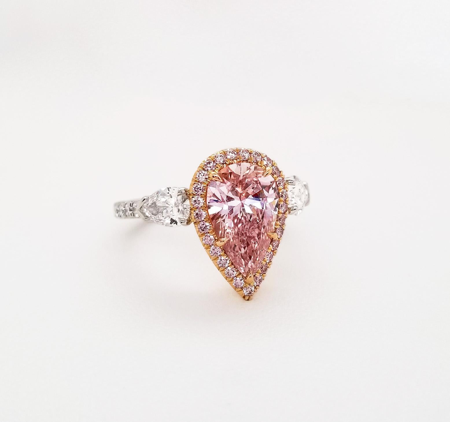 From SCARSELLI, this 2.01-carat fancy pink pear shape Diamond GIA certified (see certificate picture for detailed stone's information). The center diamond enhanced by 0.23ct round brilliant pink is flanked by a pair of 0.79ct white pear shape