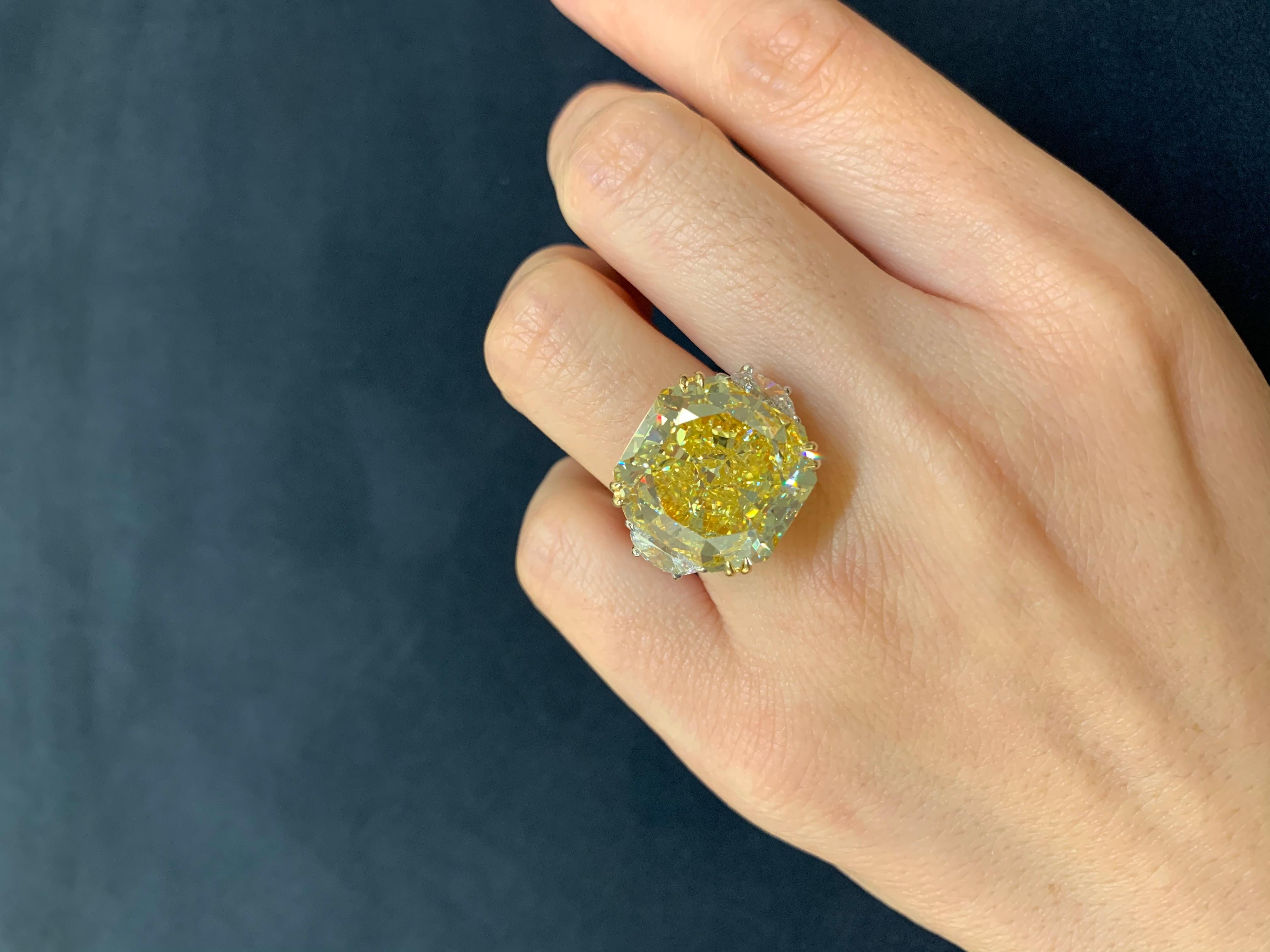 This astonishes classic ring From Scarselli features a 20-carat Fancy Vivid Yellow Radiant Cut Diamond with GIA certificate 5151483883 (see Certificate picture for detailed stone information). The center diamond is surrounded by 1.10 carat of