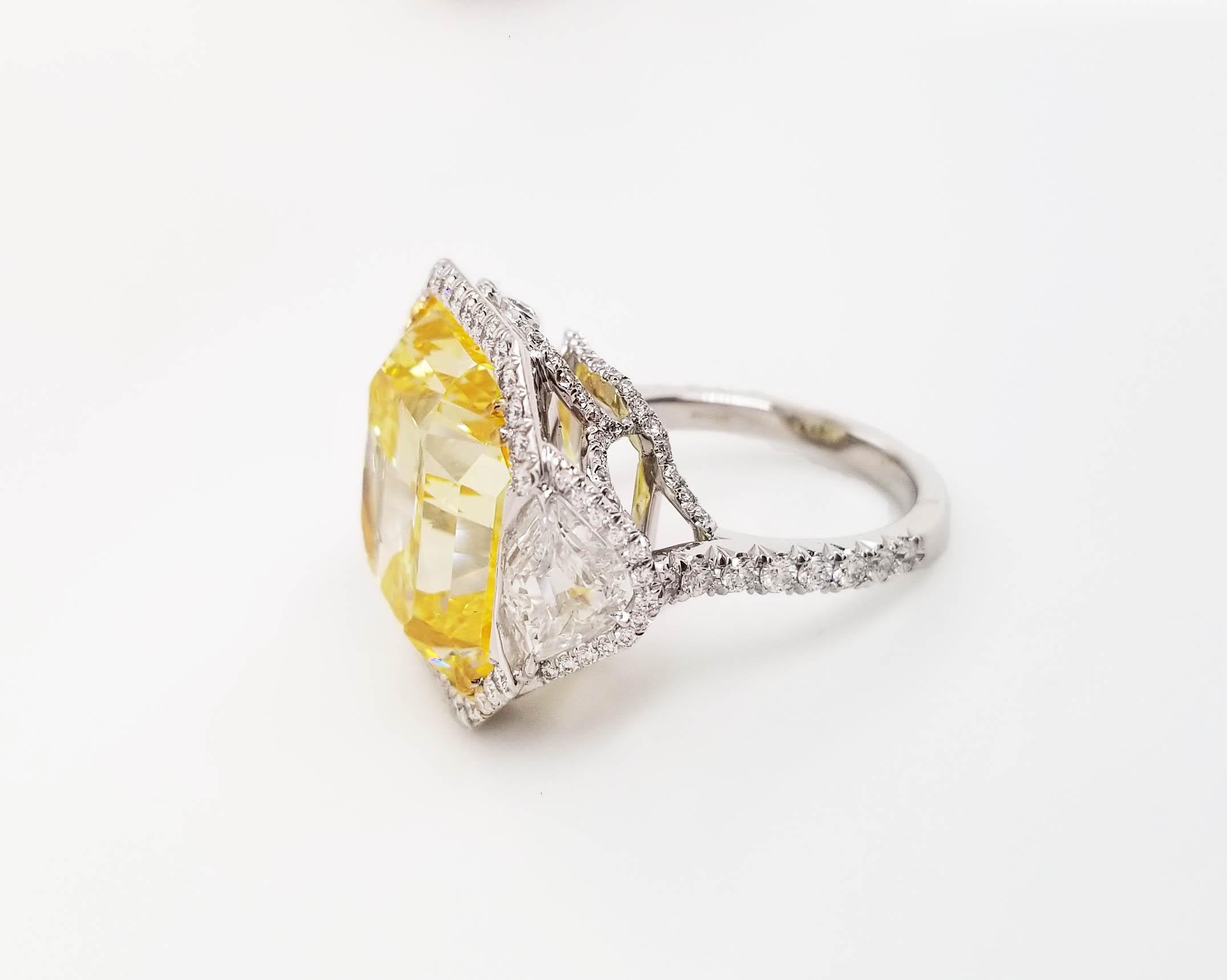 This astonishes classic ring From Scarselli features a 20-carat Fancy Vivid Yellow Radiant Cut Diamond with GIA certificate (see certificate picture for detailed stone information). The center diamond is surrounded by 1.10 carat of brilliant-cut