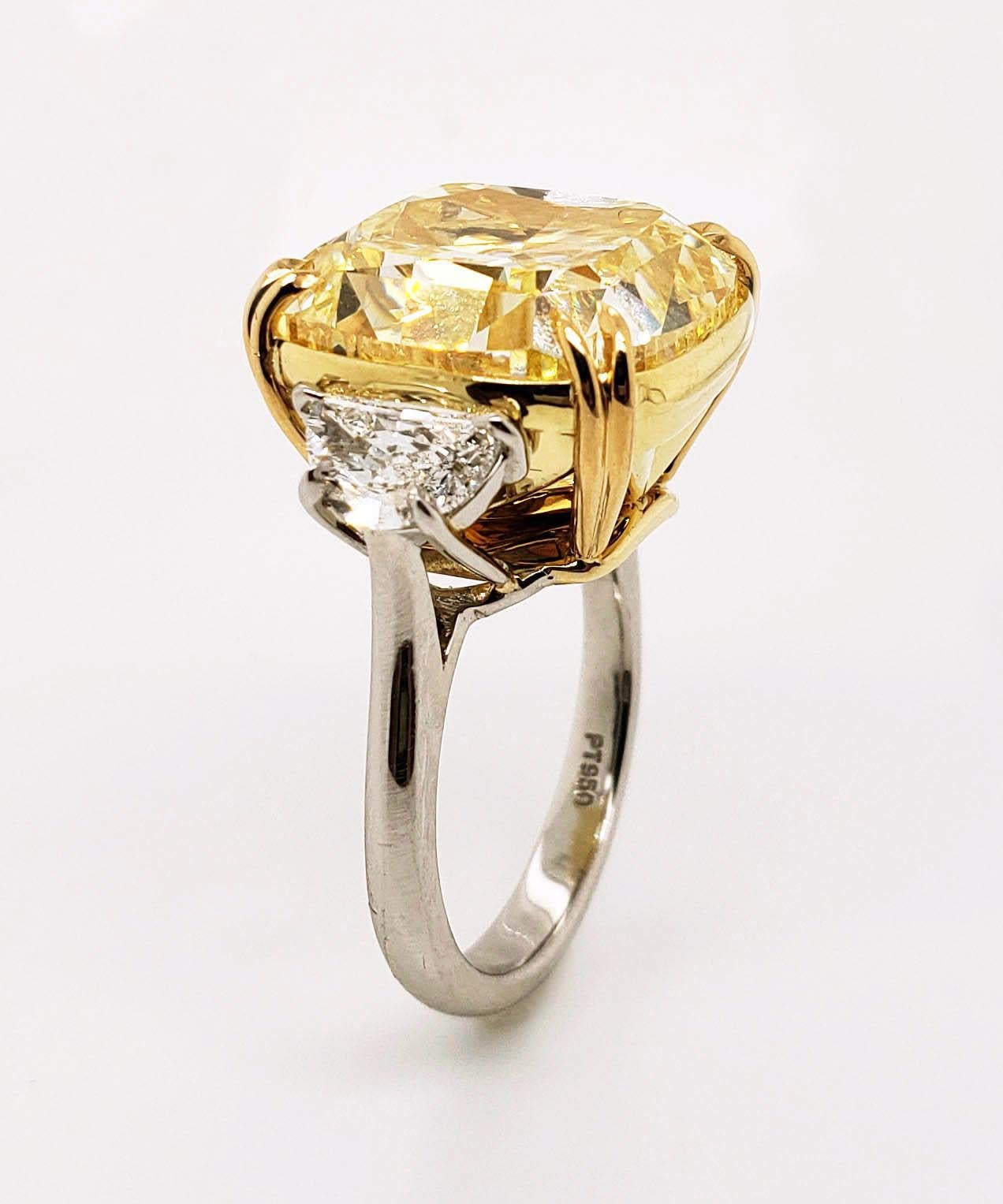 From SCARSELLI, this important 20 caratS Fancy Yellow Cushion Cut Diamond (see certificate picture for detailed stone information) flanked by a pair of half-moon white diamonds totaling 1.02ct set in handmade platinum and 18k gold mounting. This