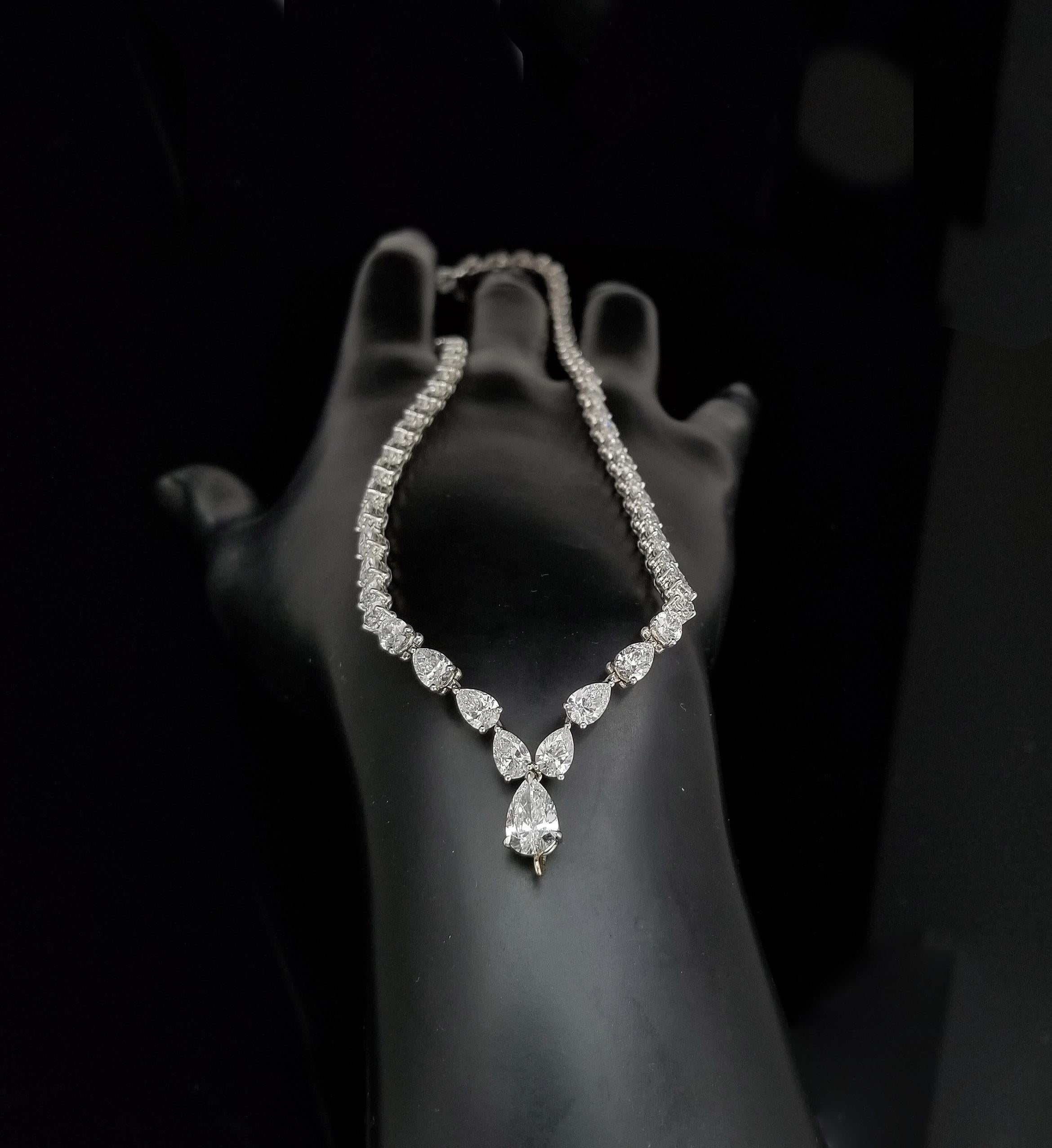 Scarselli is featuring a Platinum 22.22 carat Pear Cut Diamond Tennis Necklace. Total of 68 diamonds color graded D-E-F, and clarity VVS-SI encountered into a front drop pear cut diamond of over 1 carat (see certificate picture for detailed stone