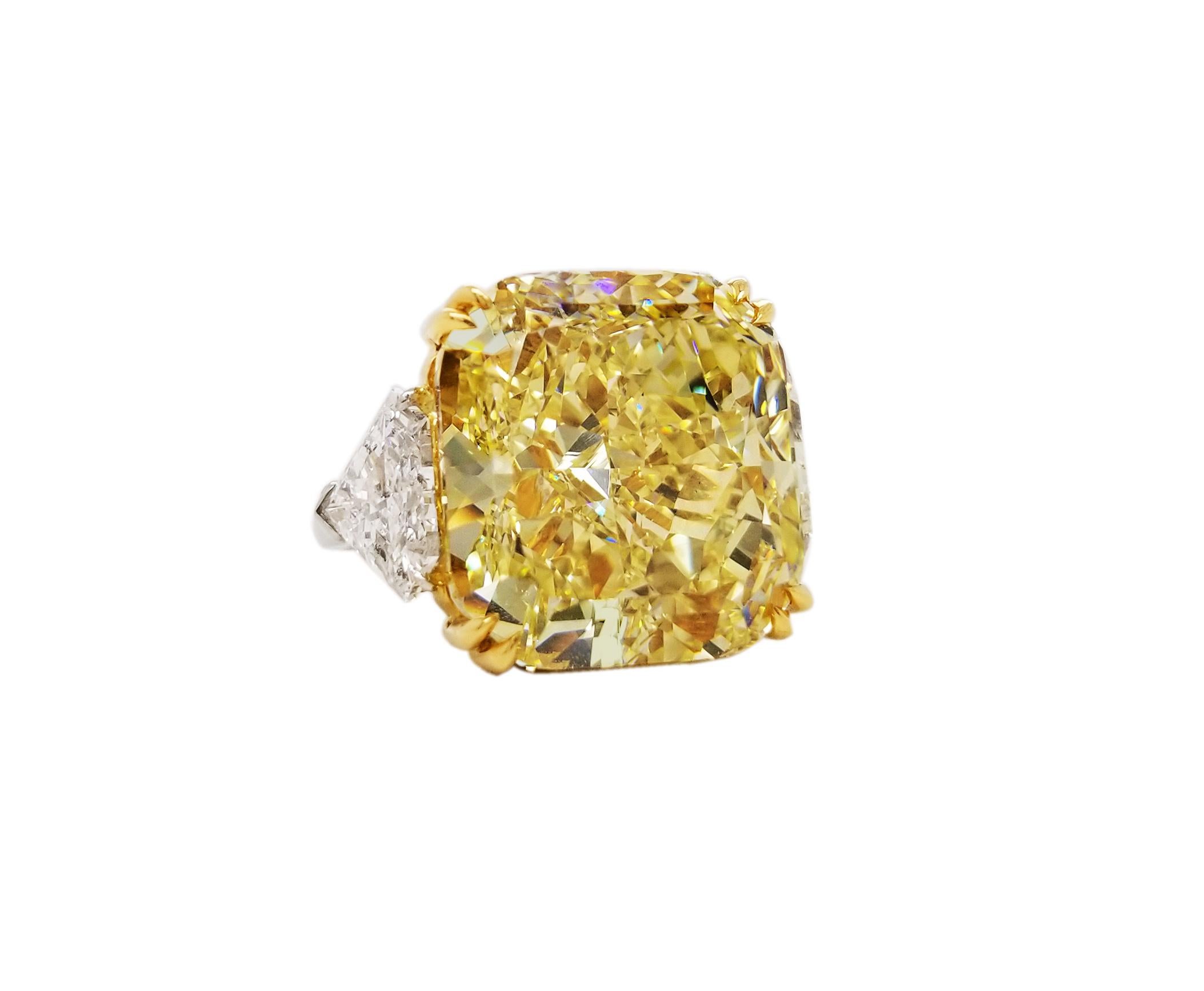 SCARSELLI is featuring a 21 + carat Fancy Intense Yellow Radiant Cut Diamond VVS1 clarity, certified by GIA ( see certificate picture for detailed stone information ) flanked by a pair of trilliant VS diamonds totaling 0.85 carats set in handmade