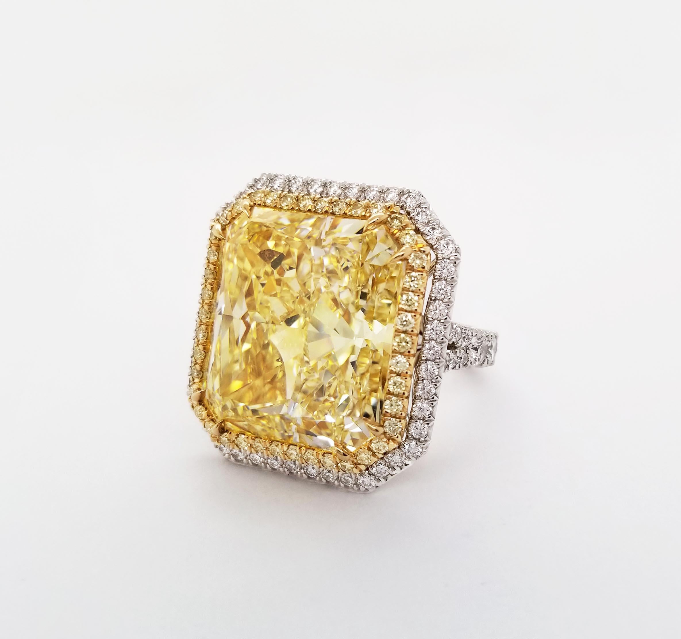 From SCARSELLI, a spectacular 24+ carat Fancy Yellow Natural Diamond set in an 18k gold hand-made setting perfectly finished all-around in platinum (see certificate pic for detailed stone's information). The center diamond is wrapped around by two