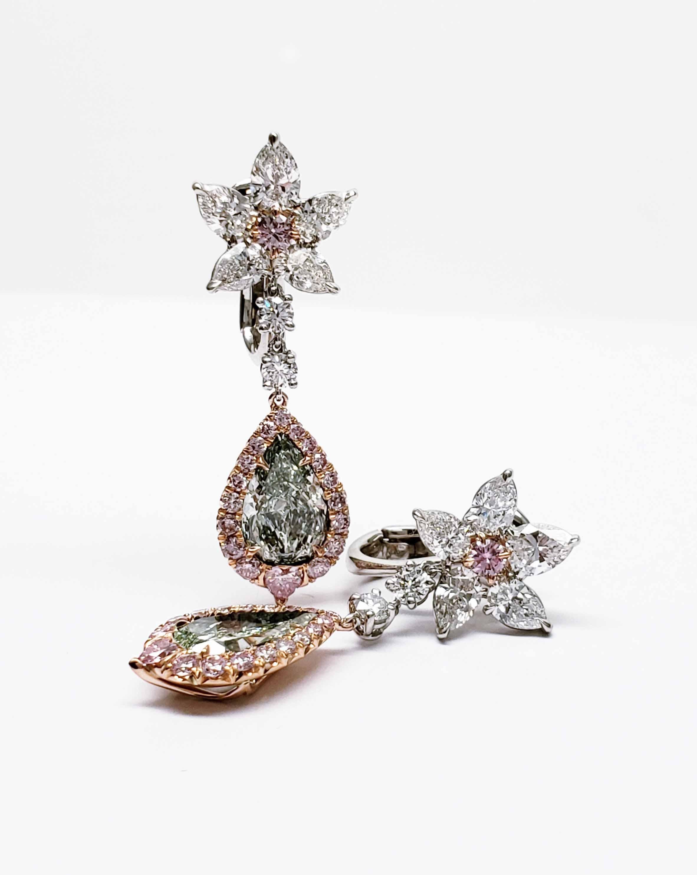 From SCARSELLI these spectacular diamond earrings are created around a very rare pair of Fancy Yellowish Green Pear shape diamonds (2 = 3.30 carat total) of VS1 and VS2 clarity.  Pink diamond accents surround the pear shape diamonds and also center