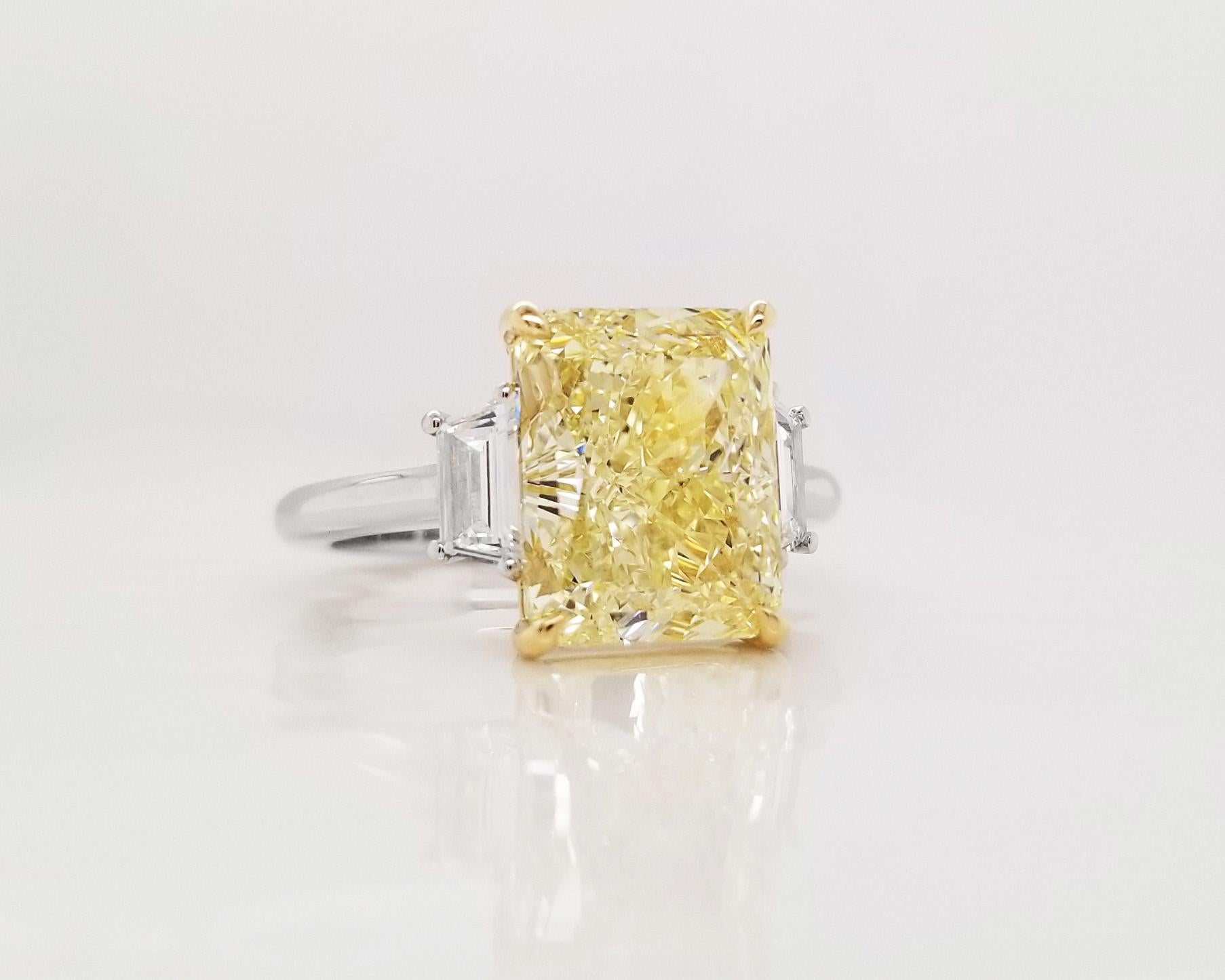 From SCARSELLI, this beautiful engagement ring features an over 5-carat Fancy Light Yellow radiant cut diamond of VVS2 clarity (see certificate picture for detailed main stone's information) flanked by 2 trapezoids totaling 0.41ct (0.20each).