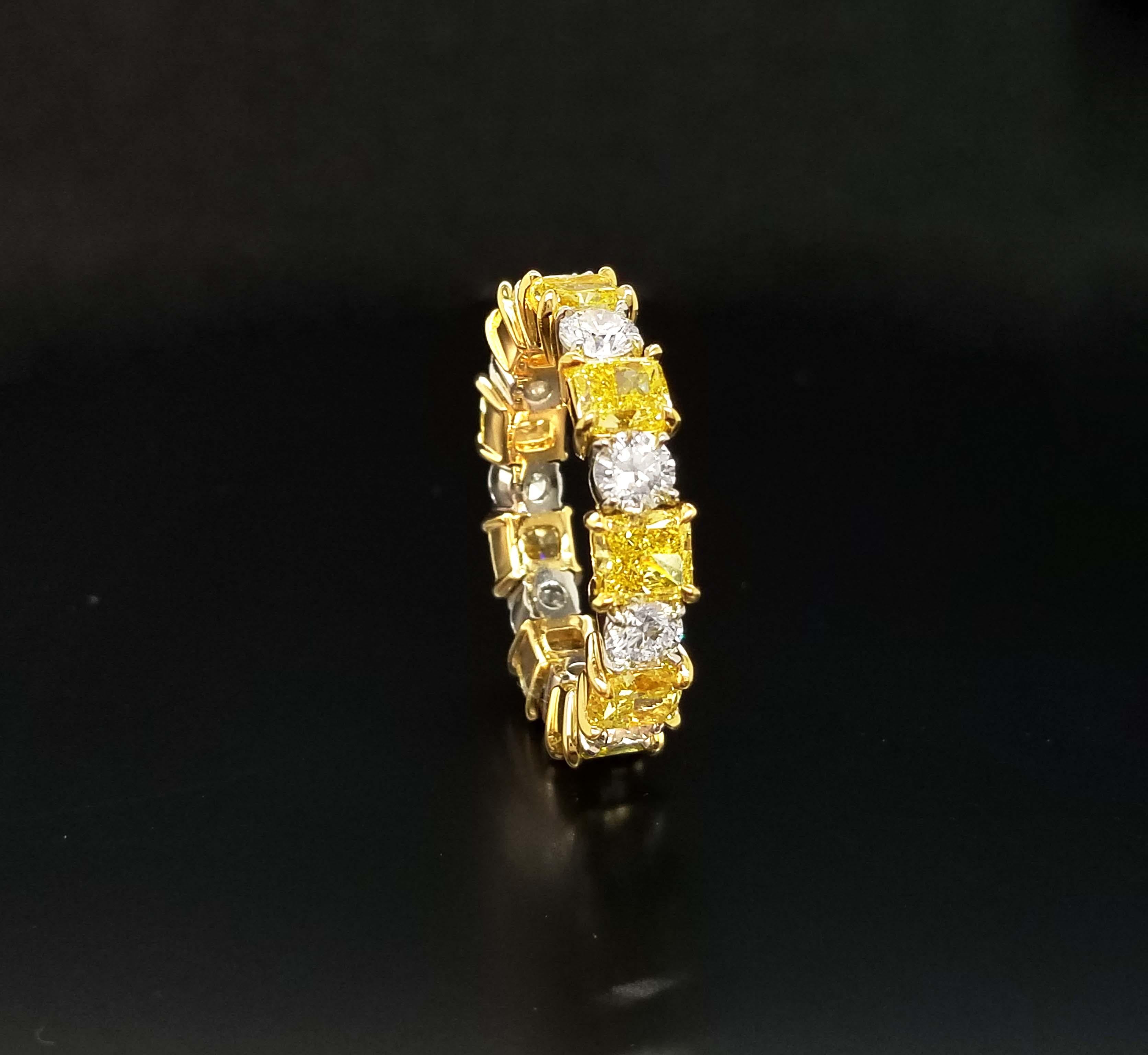 This Fancy duo color diamonds Eternity band is a pleasure to wear every day and contains 3.77 carats of natural fancy intense yellow diamonds in 9 stones GIA Certified (pictures of some of the certificates are available for detailed stone purpose)