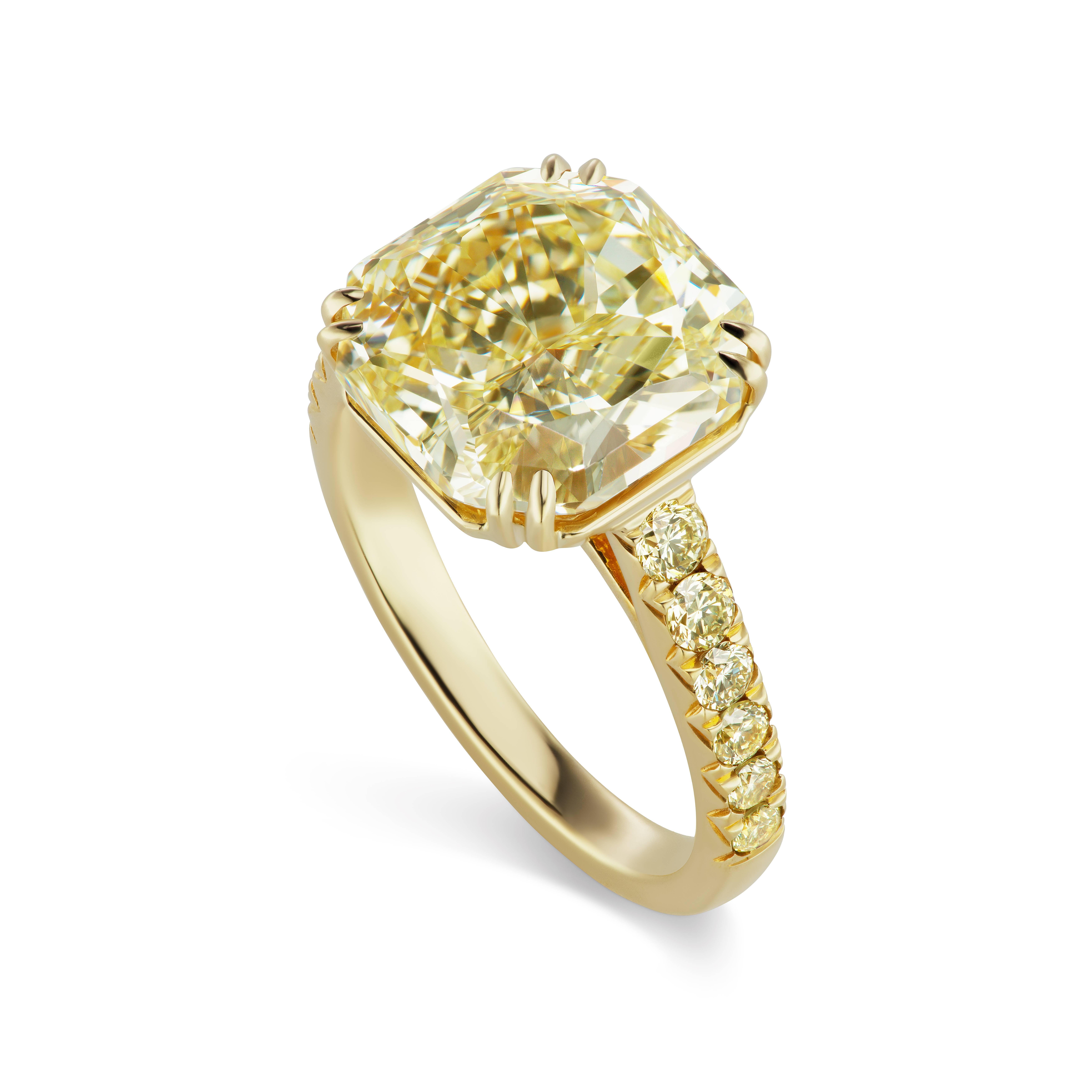 This Scarselli 5.69 carat  Fancy Light Yellow Radiant cut diamond is VVS2 clarity and is beautifully set with .44 carats of matching yellow VS clarity diamonds in 18 karat Yellow Gold.  A lovely neutral to wear with virtually any ensemble that