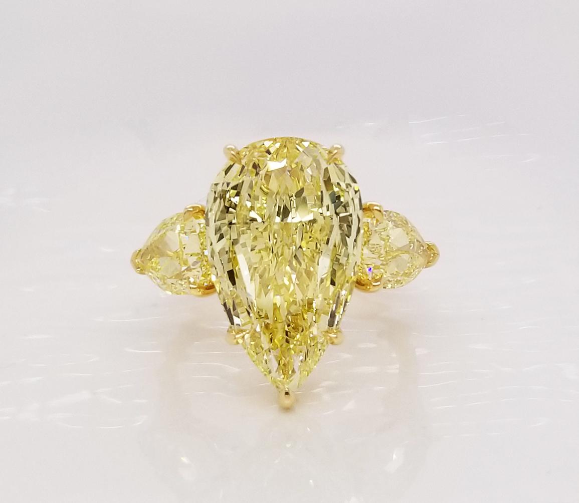 From SCARSELLI, this vibrant and spectacular 6.61 carat Fancy Yellow Diamond (VVS2 clarity) flanked by a couple of GIA pear shaped Fancy Yellow diamonds 1.27 & 1.30 carats respectively (see certificate pictures for detailed information on the