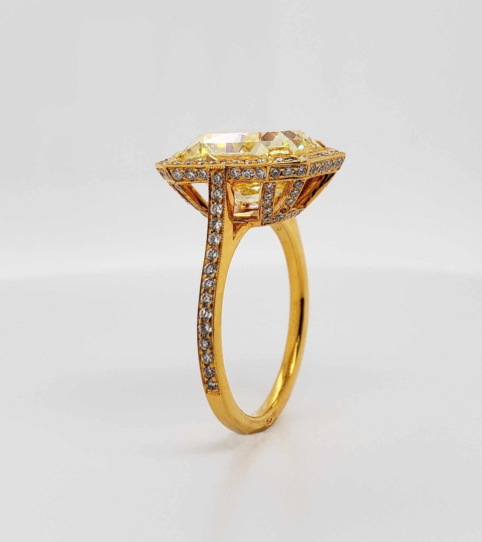 From SCARSELLI, a simply important ring featuring a 6.70 carat Fancy Vivid Yellow Radiant cut diamond (GIA VS2) surrounded by 0.44 carats of small white diamonds in a coordinating handmade mounting of 18 karat yellow gold.
Vivid yellow diamonds of