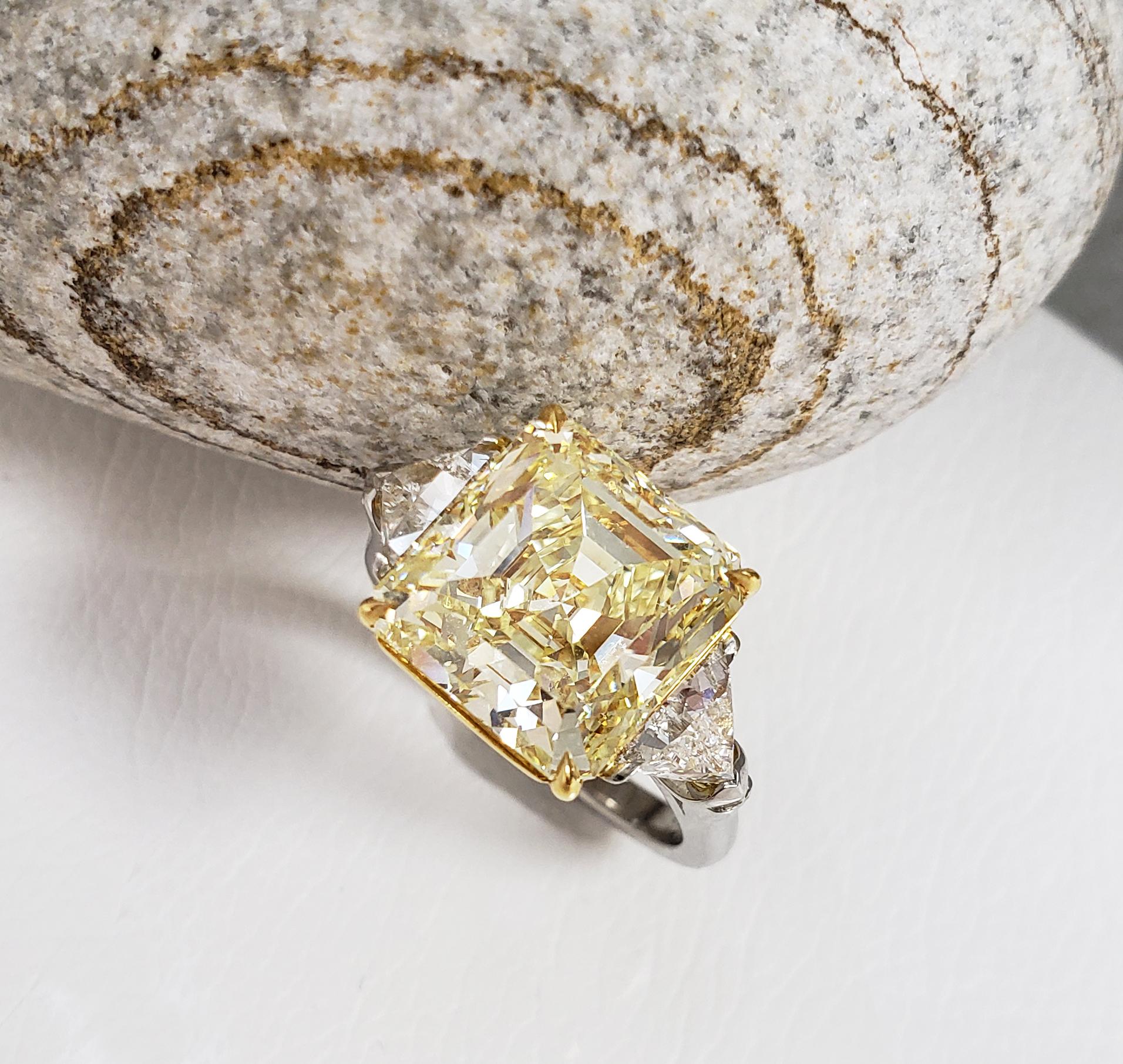 This Beautiful Classic Ring From Scarselli features a 7 carat Fancy Yellow Emerald Cut Diamond with GIA certificate 1182943182 (see certificate picture for more detailed stone's information). The center diamond is accompanied by two white G