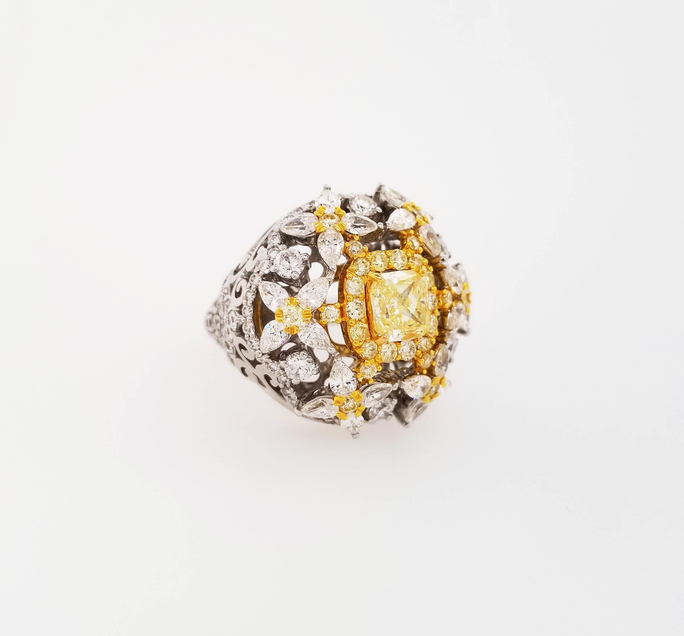 From Scarselli, this gorgeous cocktail ring featuring a 1.00 carat fancy yellow radiant shaped cut diamond, SI1 clarity GIA certified and set in an 18k yellow and white gold. The natural look of this ring is set off with a variety of sizes and