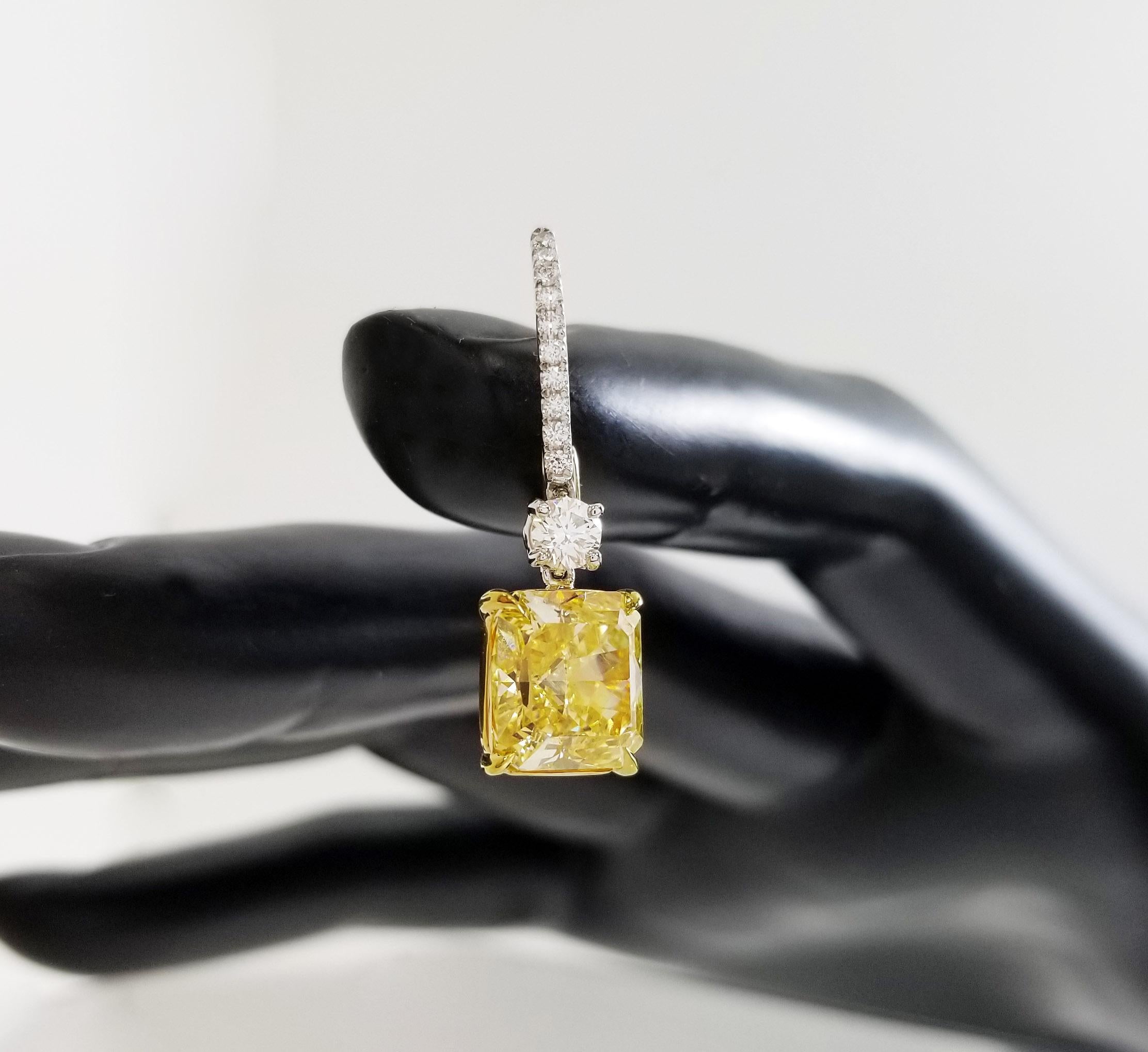 An exquisite pair of intense yellow diamond earrings – each radiant cut diamond is 3.25 and 3.27 carats, respectively. The natural, GIA-certified fancy-color diamonds are both of VVS1 clarity – set on 18k yellow gold and platinum. The hoop of the